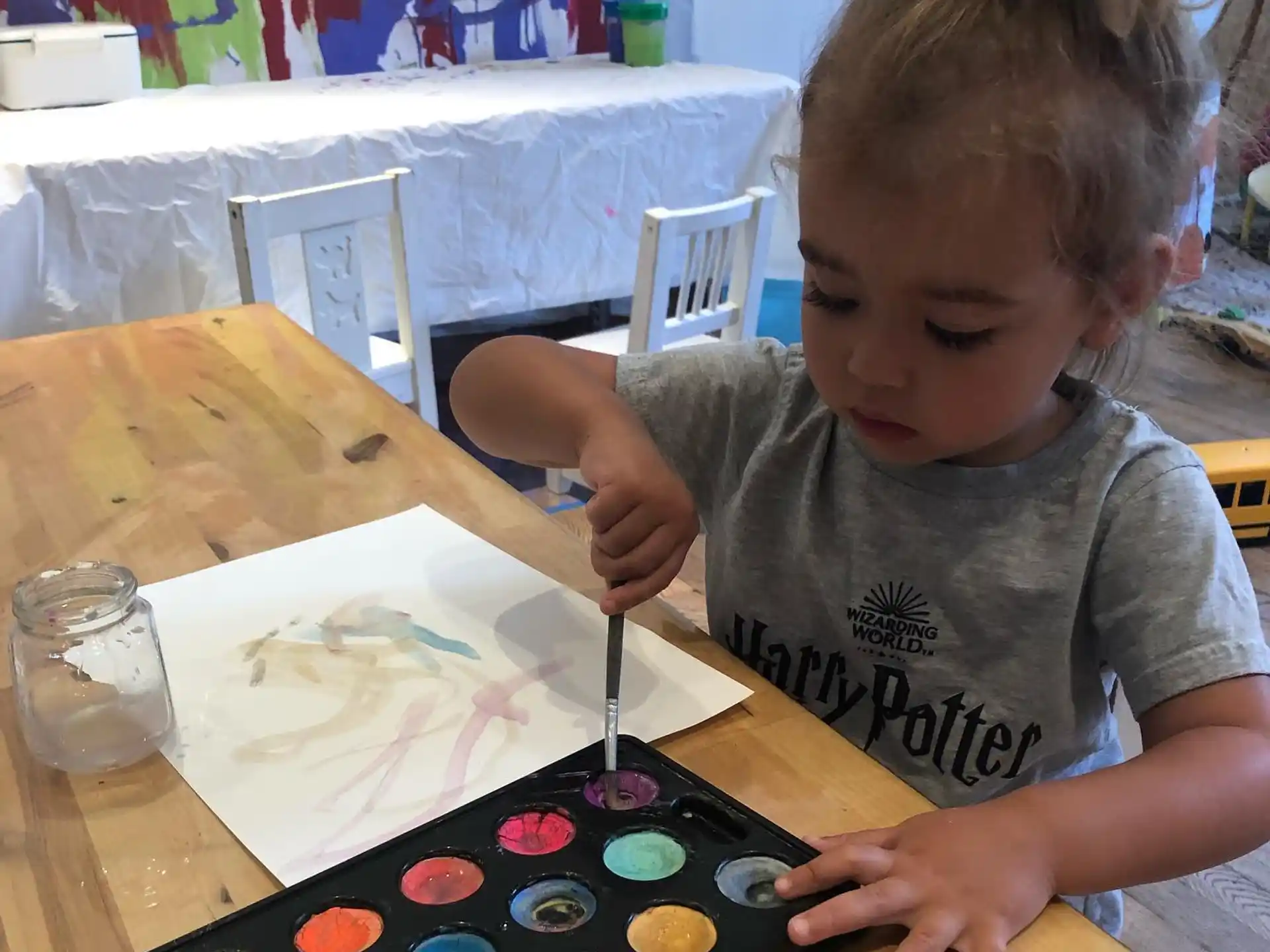 a child painting on a table