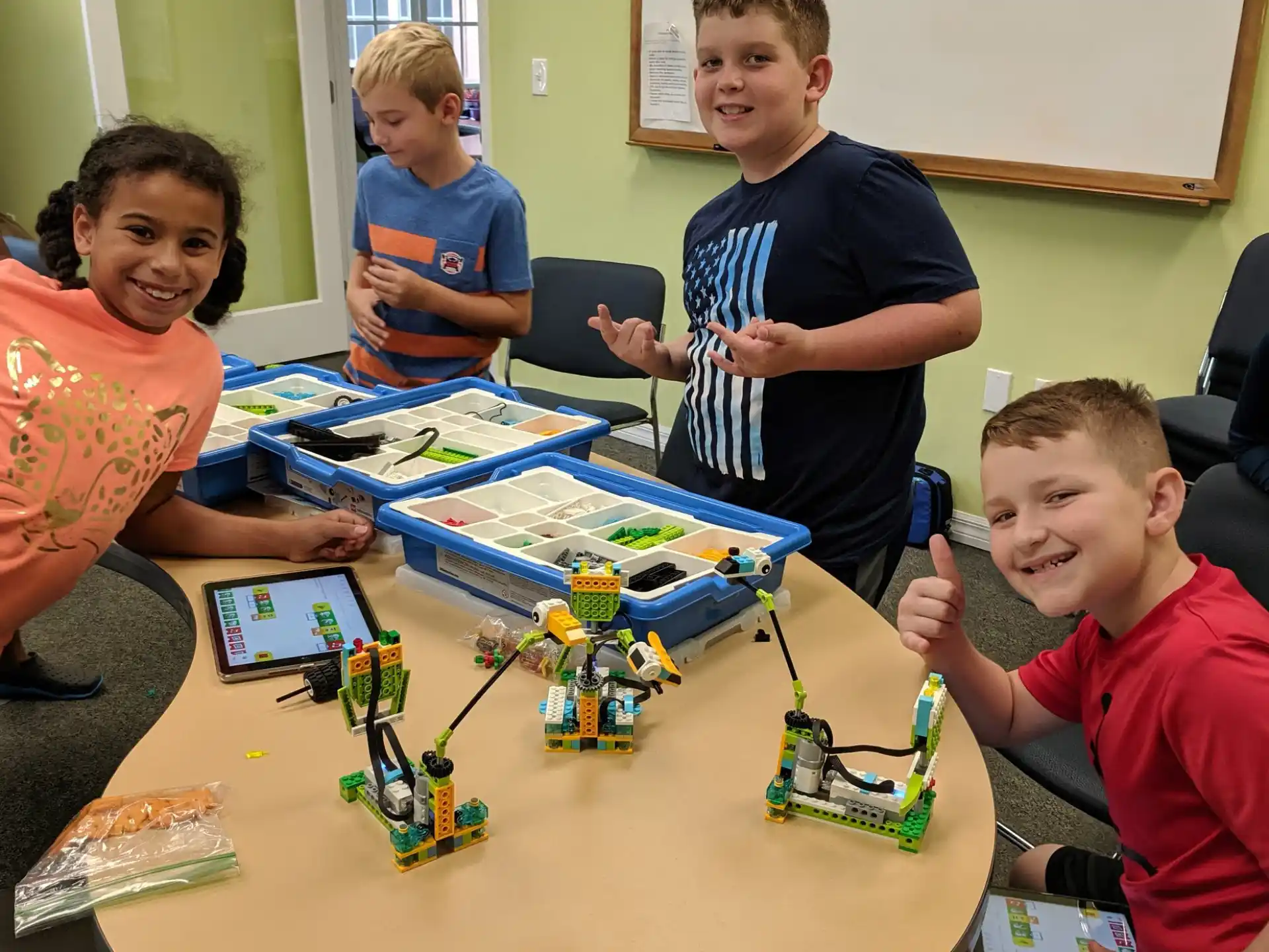 a group of boys sitting around a table with a board game