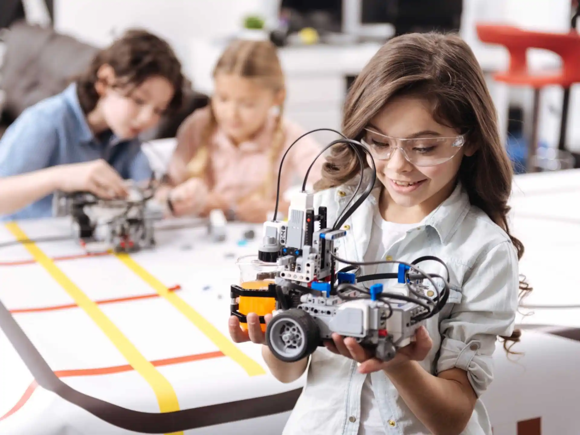 a group of children playing with a toy car