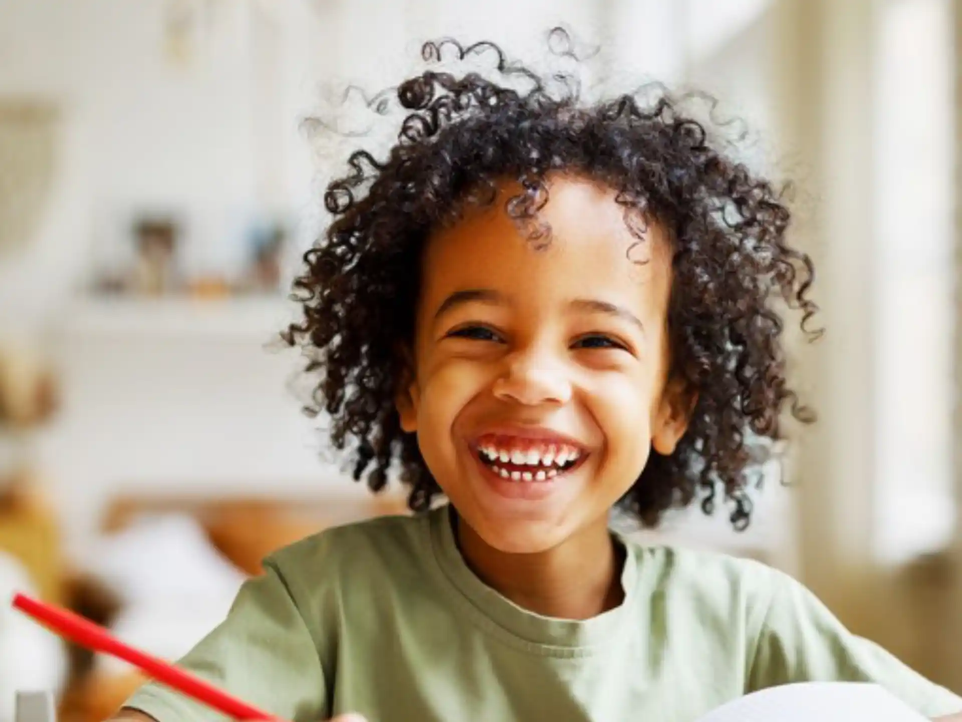 a smiling girl with curly hair