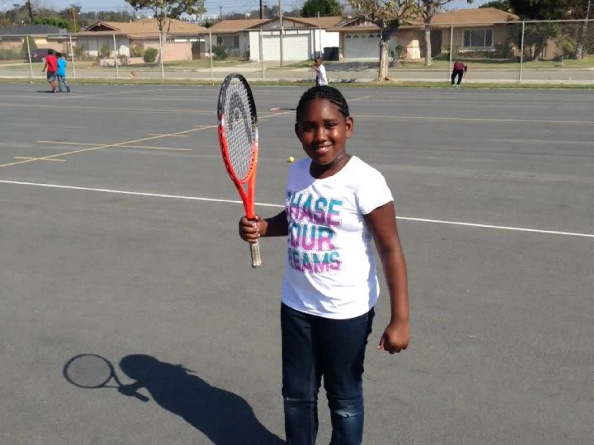 a boy holding a tennis racket