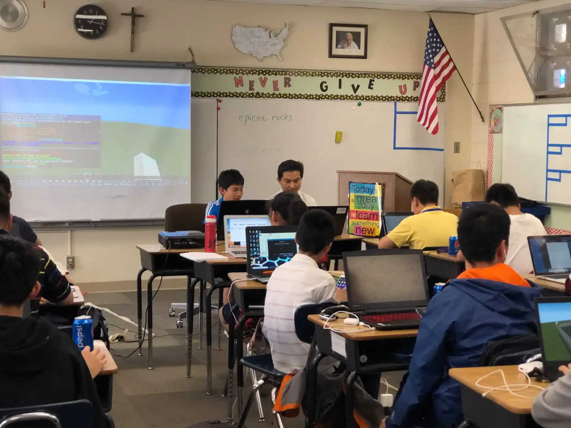 a group of people sitting at desks with computers