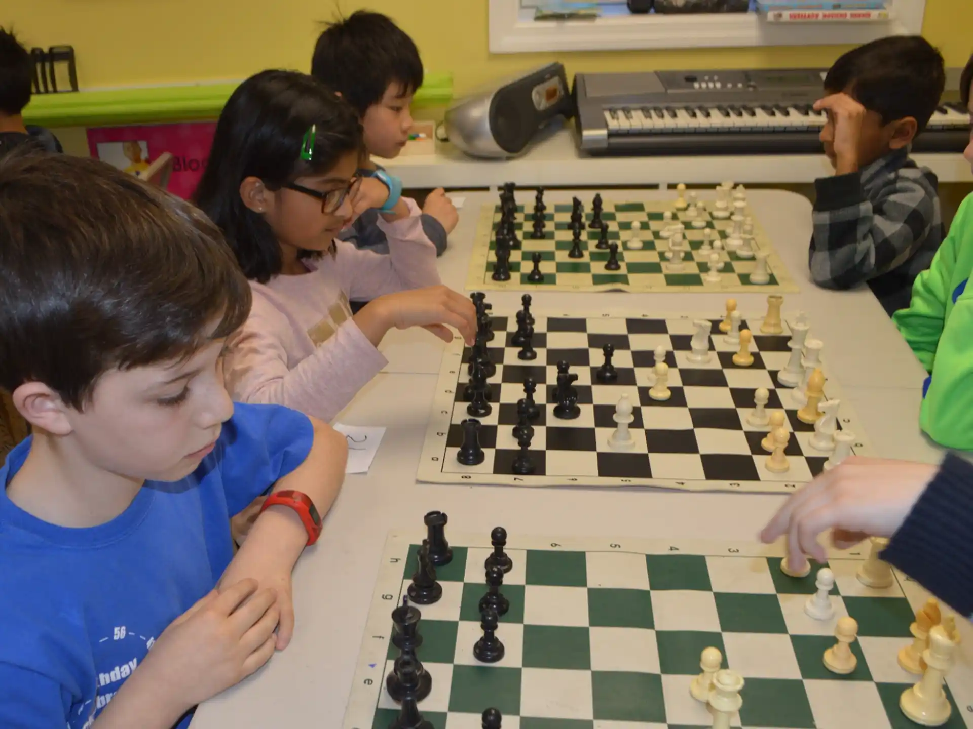 a group of children playing chess