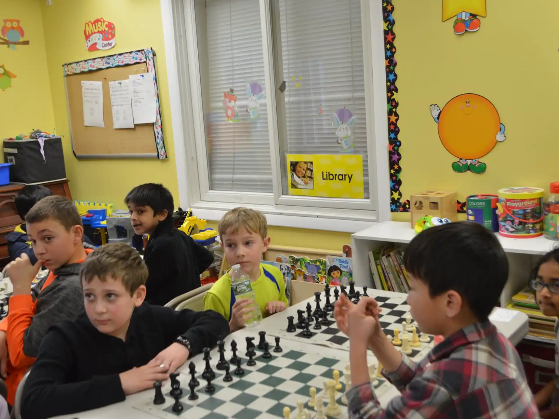 a group of children sitting around a table