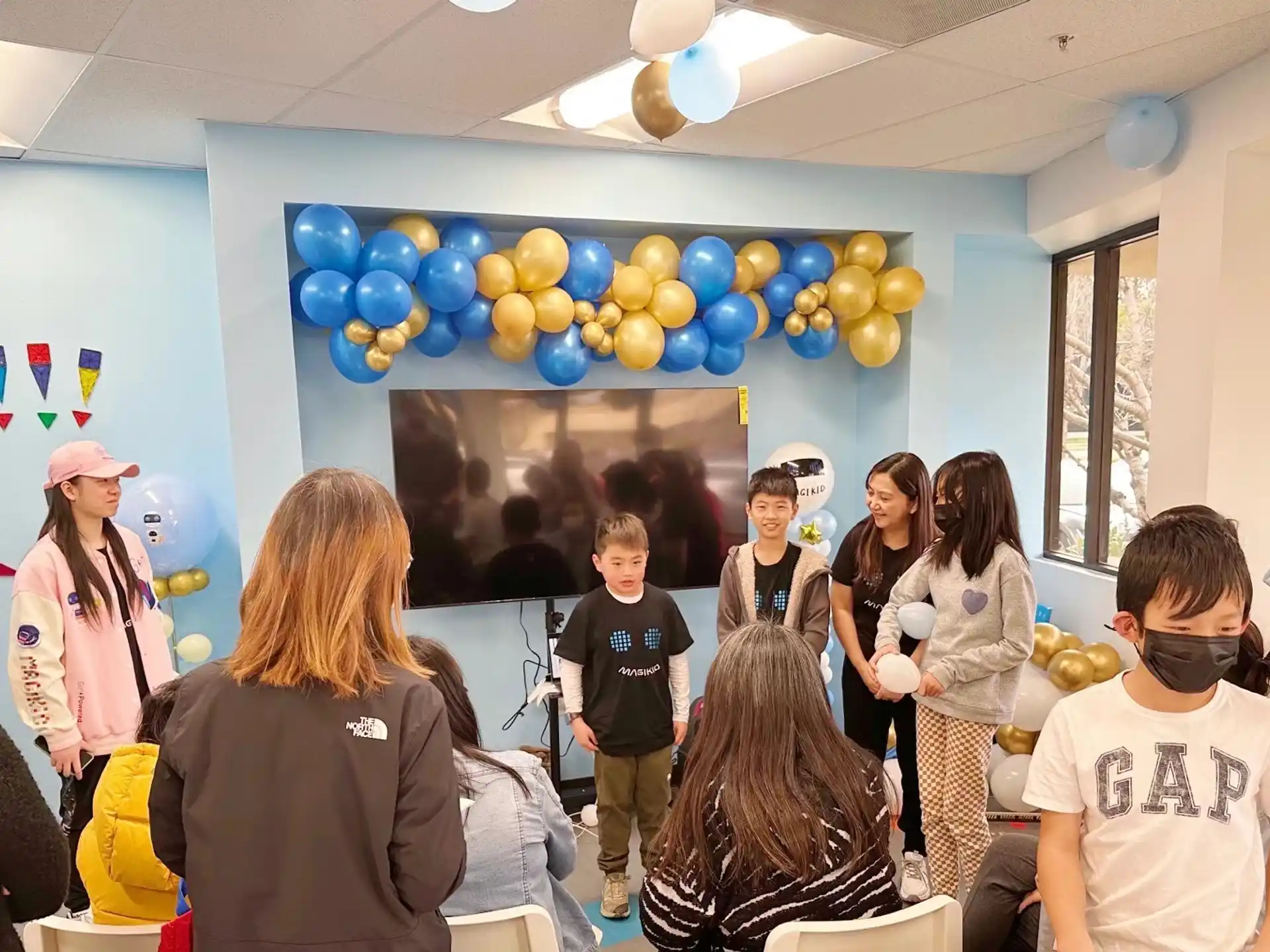 a group of people in a room with balloons
