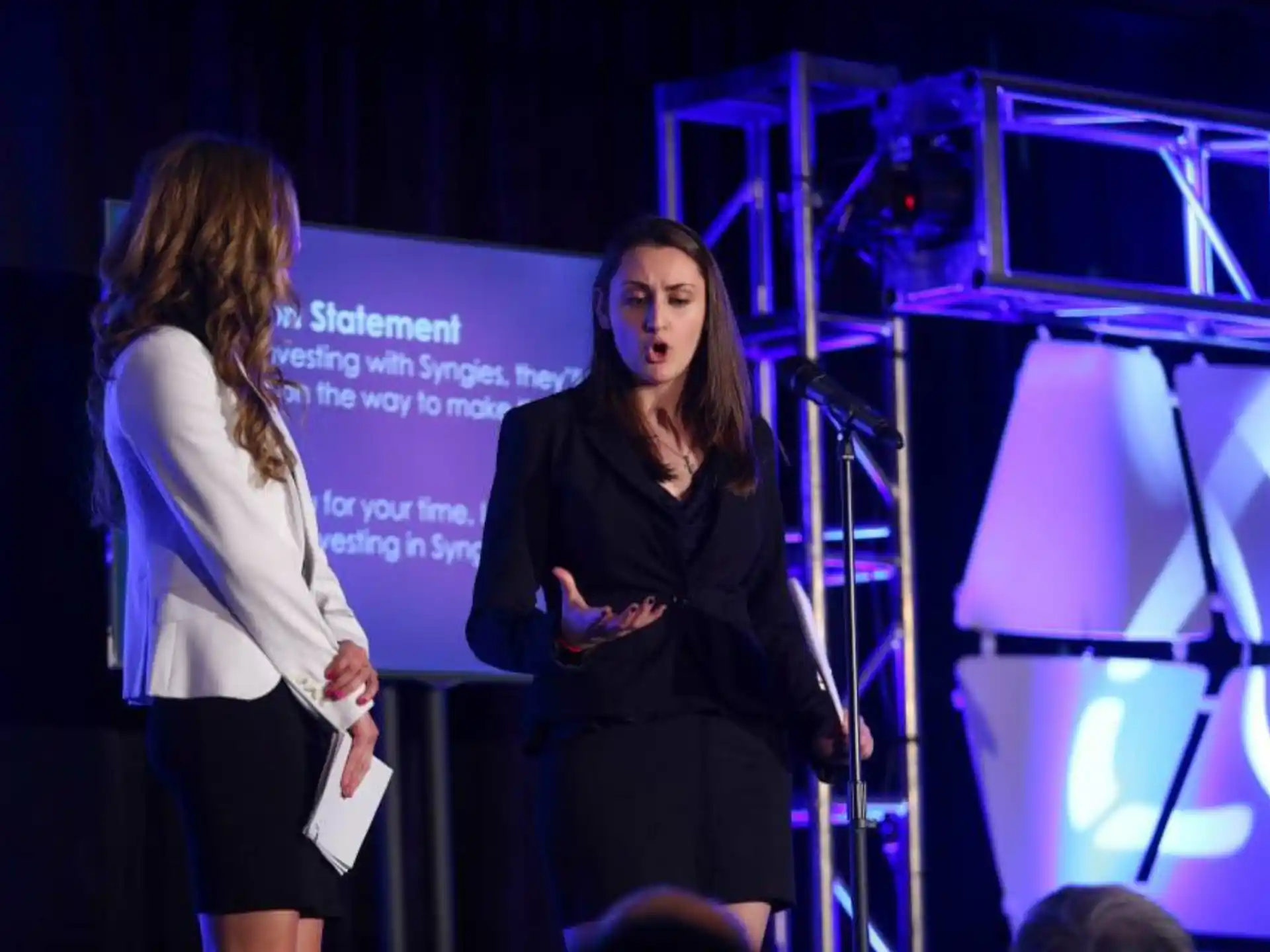 a person standing next to another woman