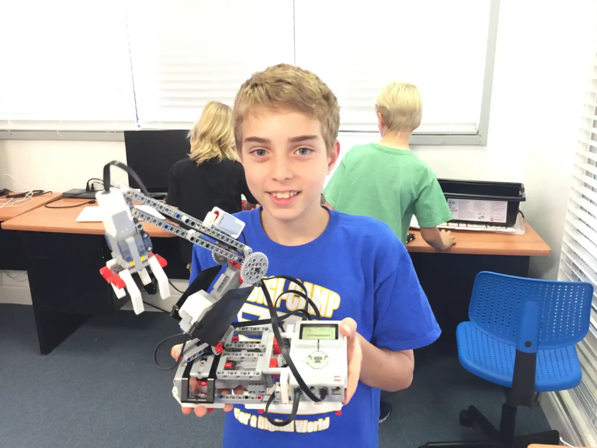 a boy holding a toy robot