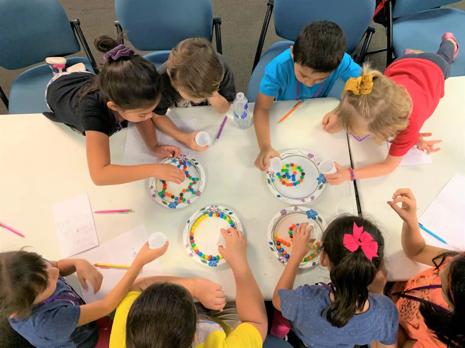 a group of children eating at a table