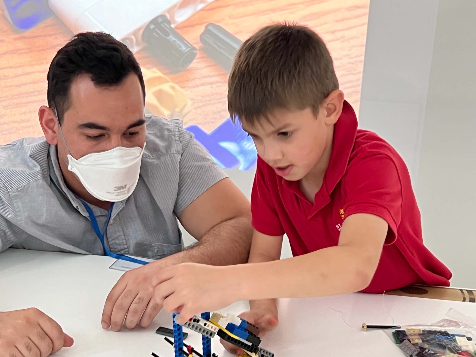 a man and a boy looking at a paper