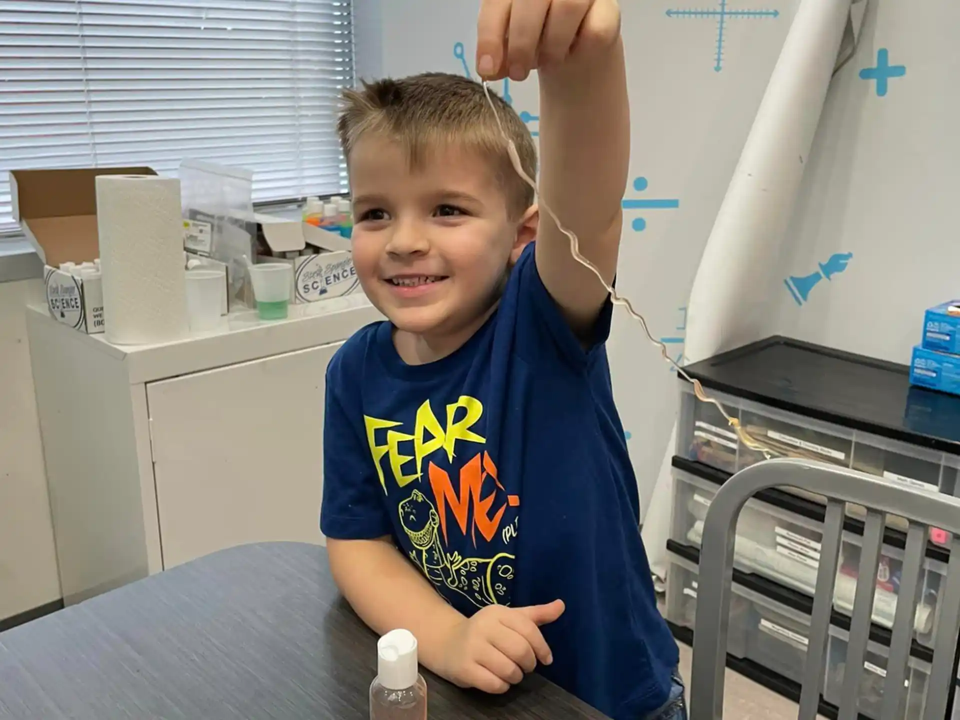 a boy holding a paper