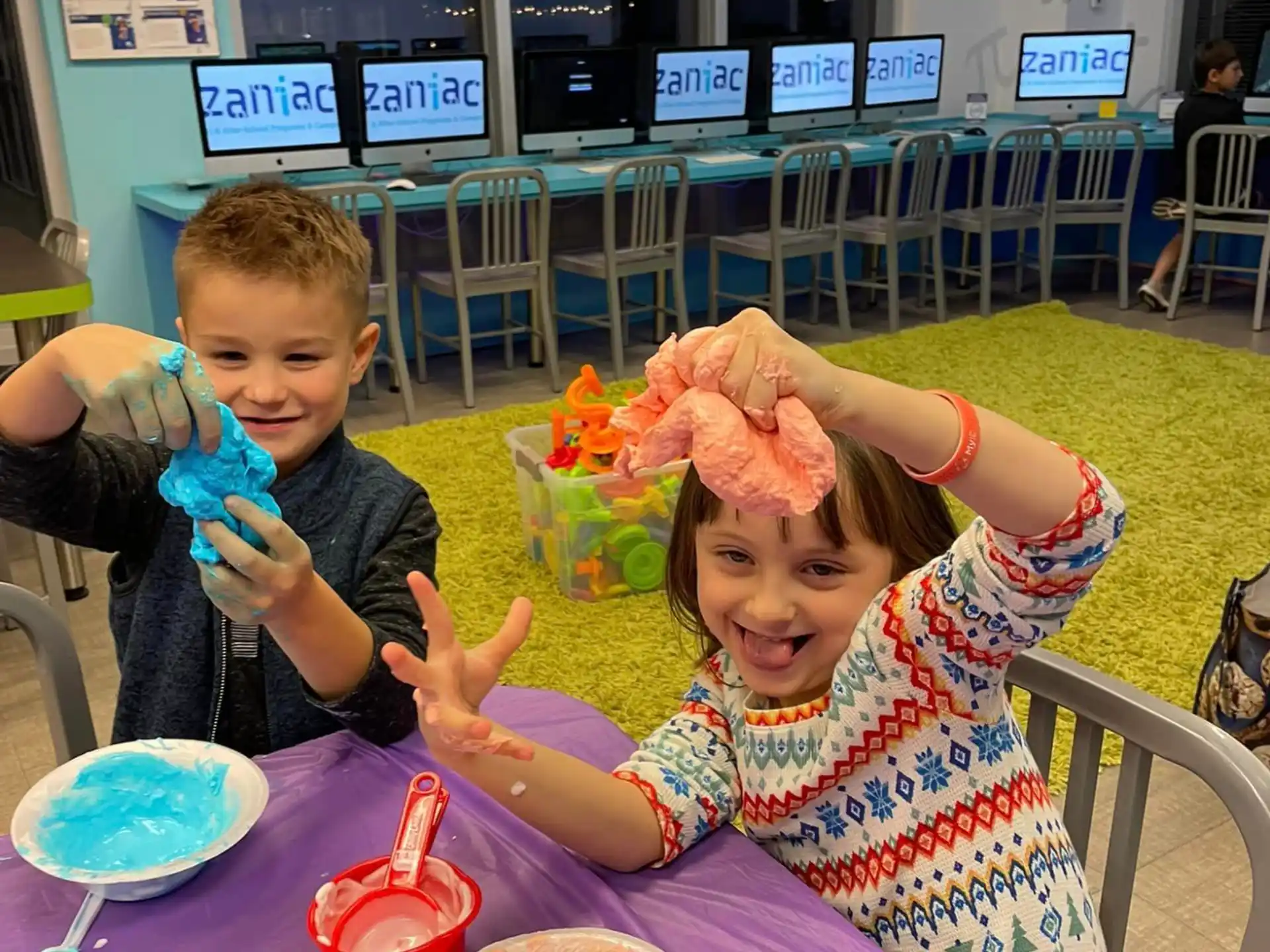 a couple of kids eating at a table
