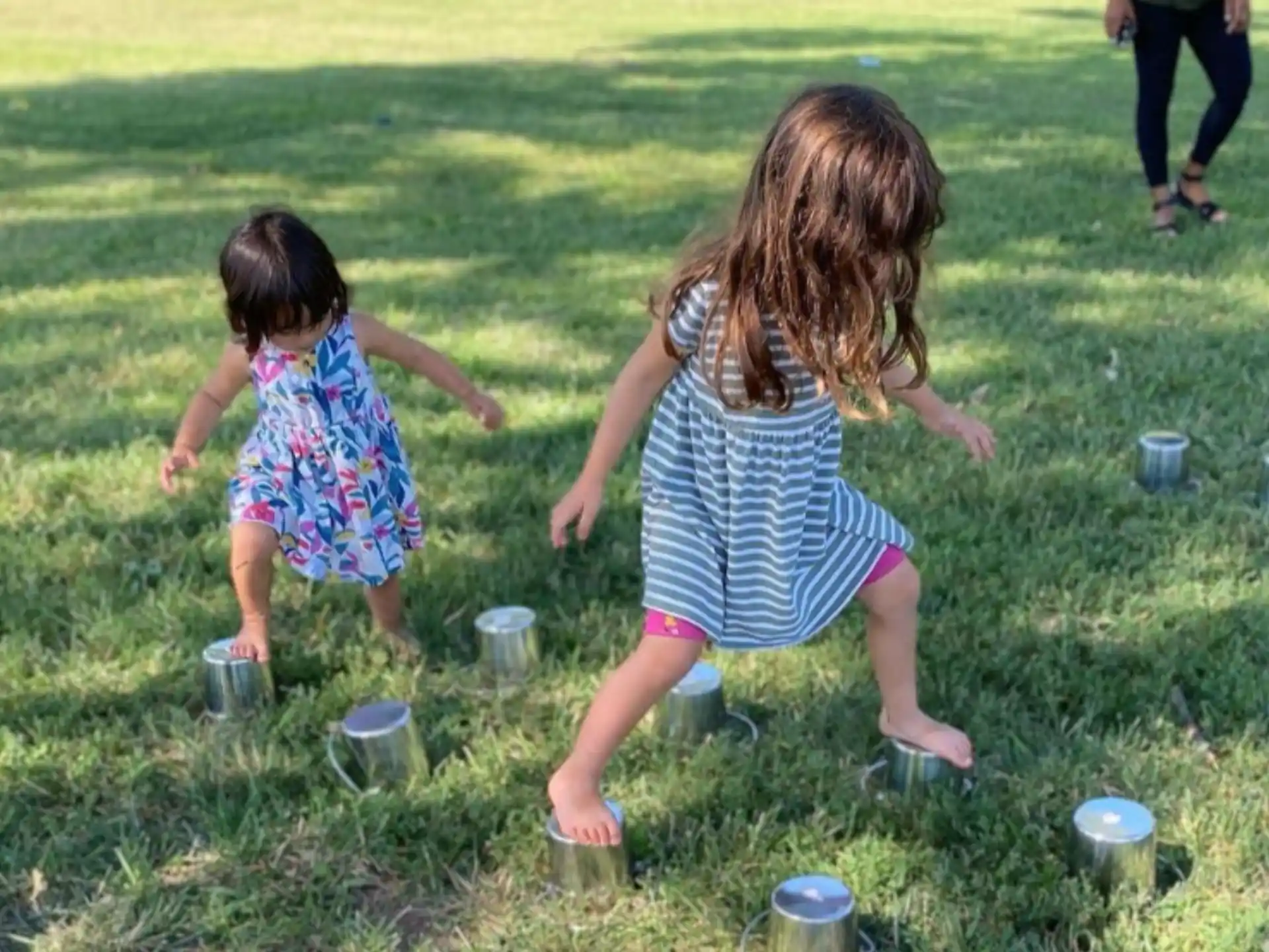 a couple of girls playing in the grass