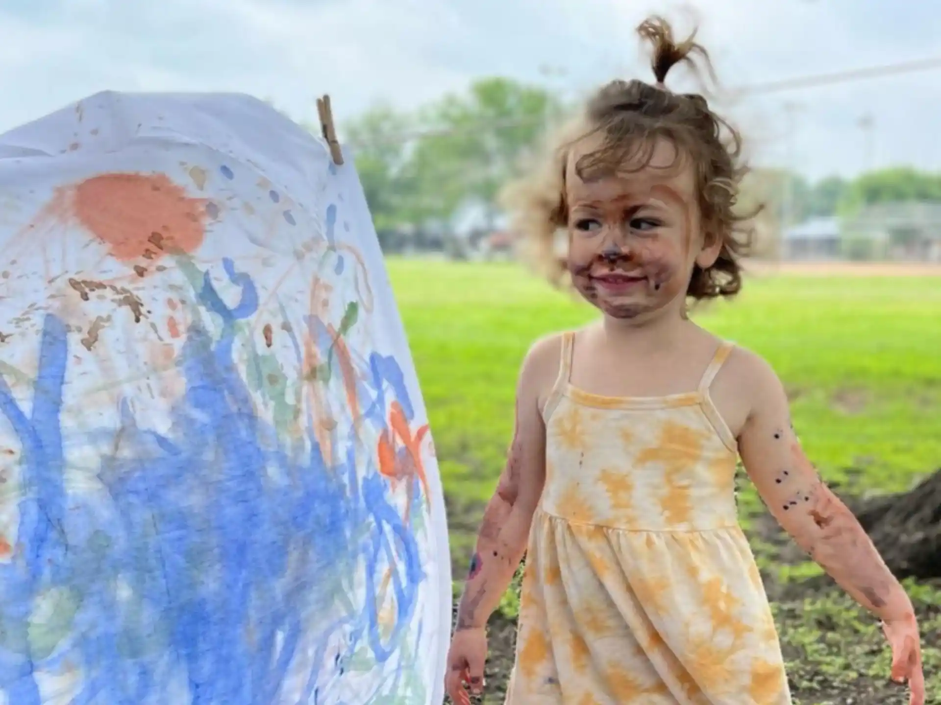 a girl holding a painting