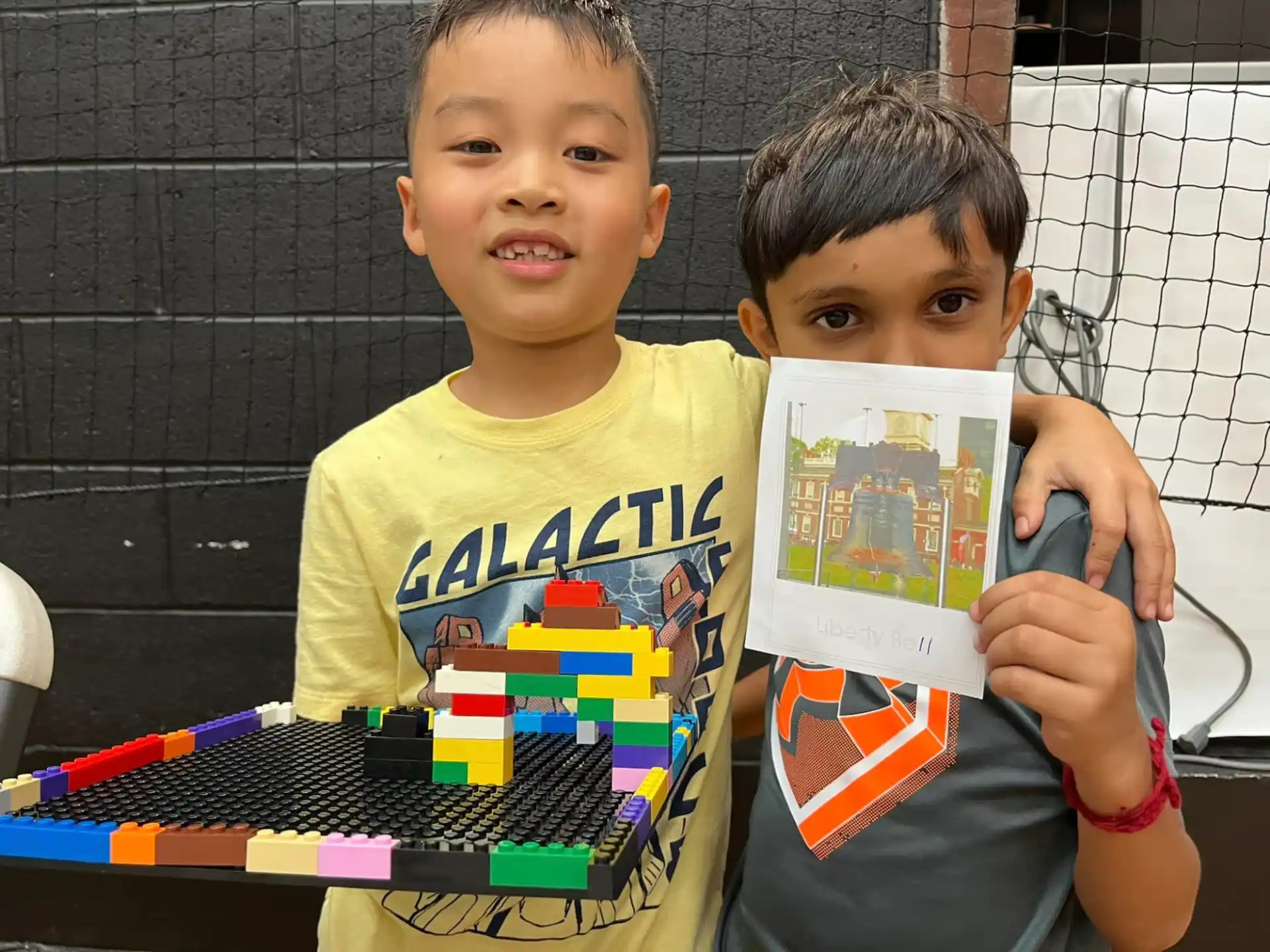 two boys holding a book