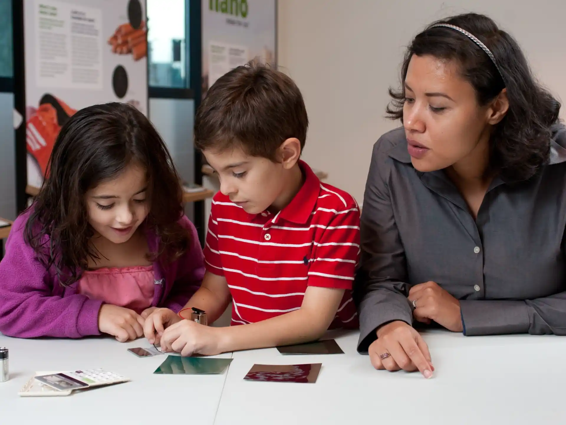 a person and a child looking at a book