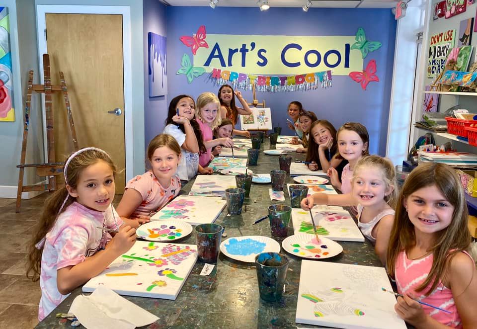 a group of children eating at a table