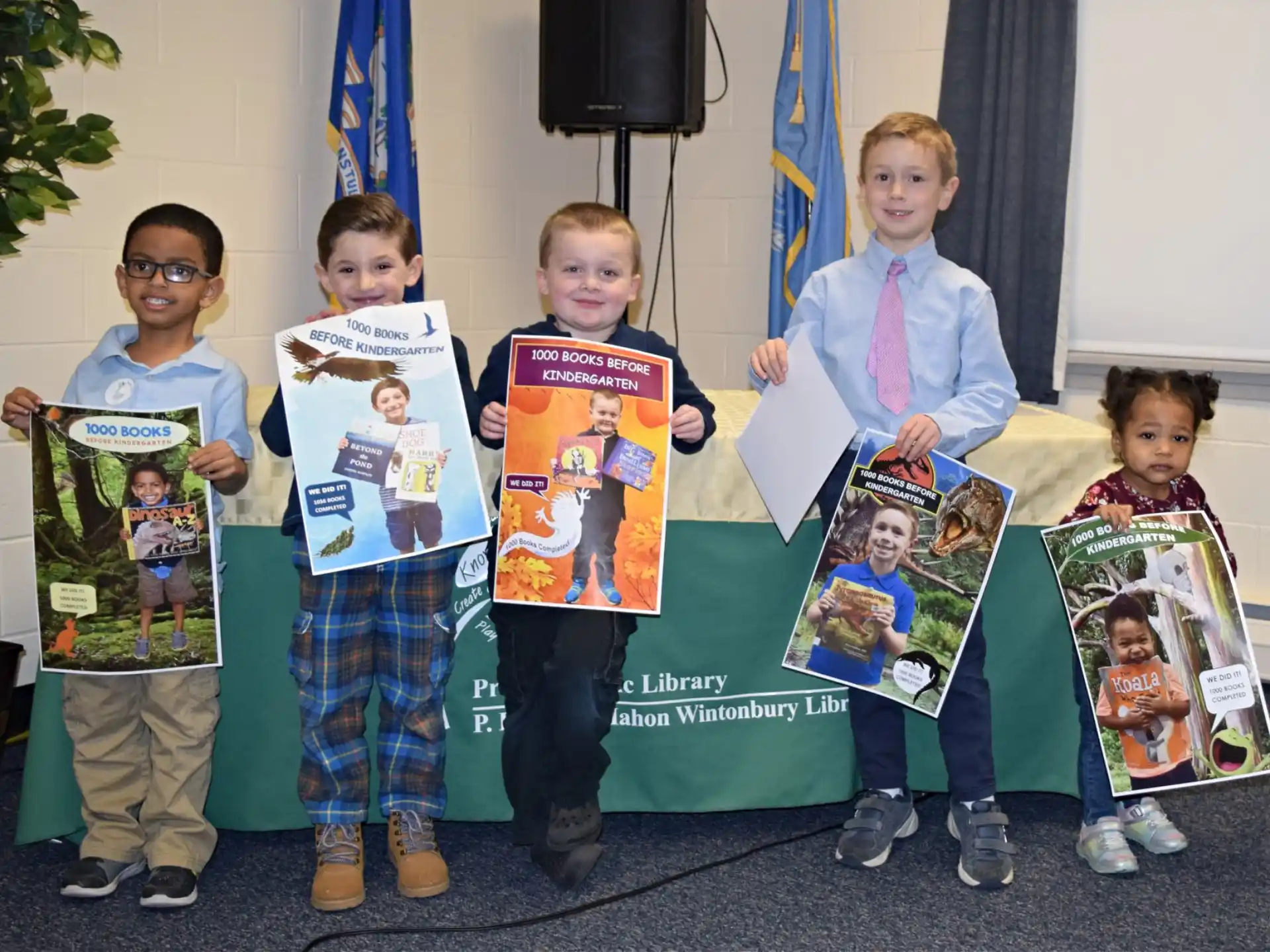 a group of children holding books