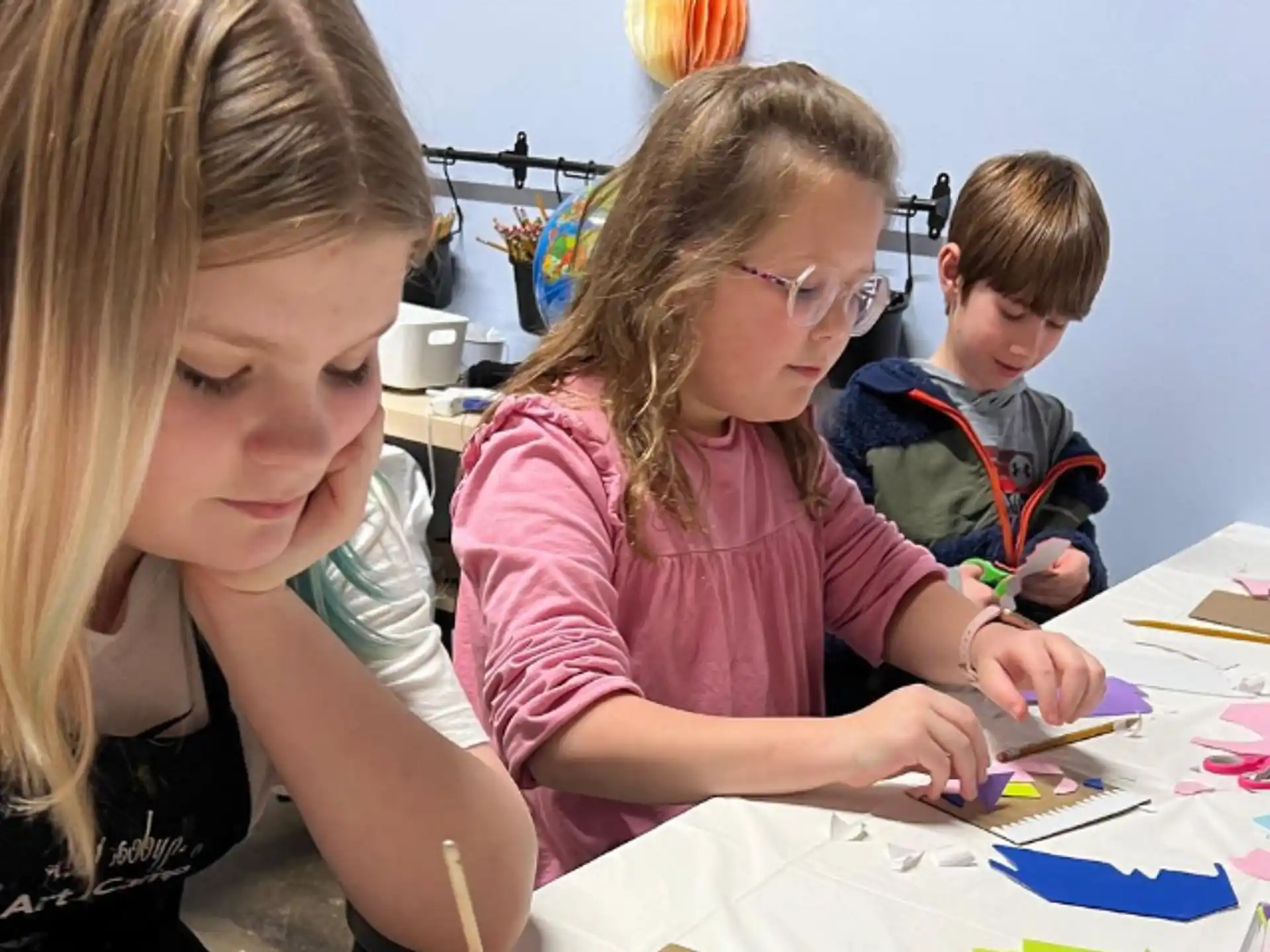 a group of children sitting at a table