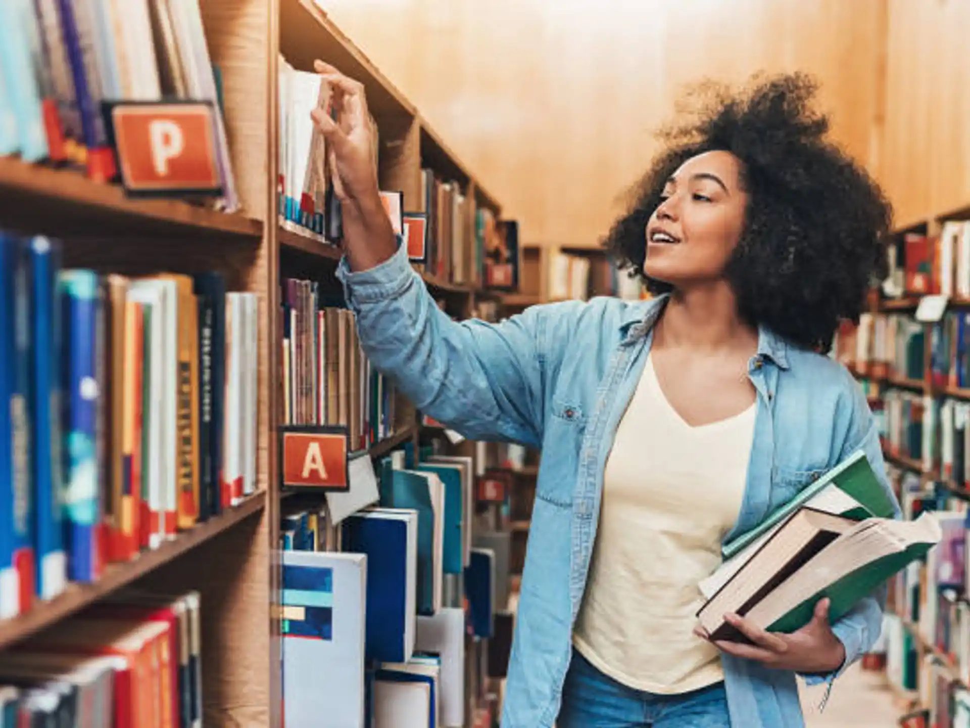 a person holding a book in a library