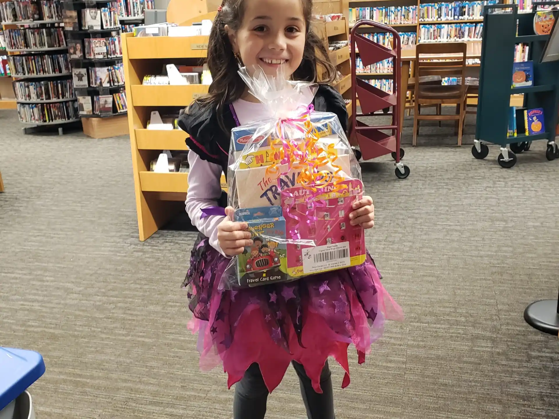 a girl holding a toy in a library
