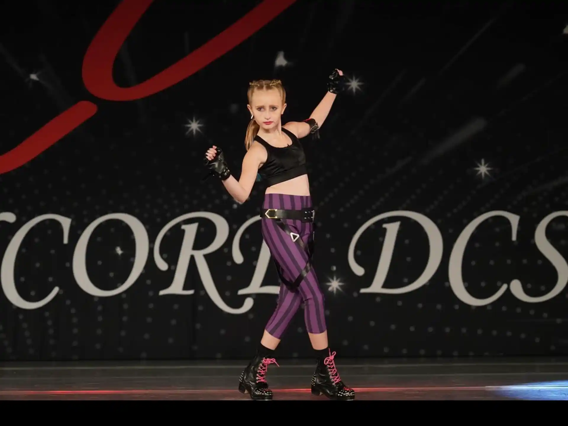 a woman wearing roller skates and holding her arms up