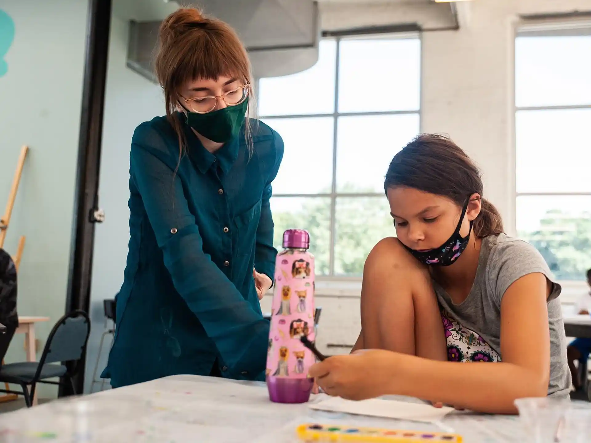 a woman and a girl painting