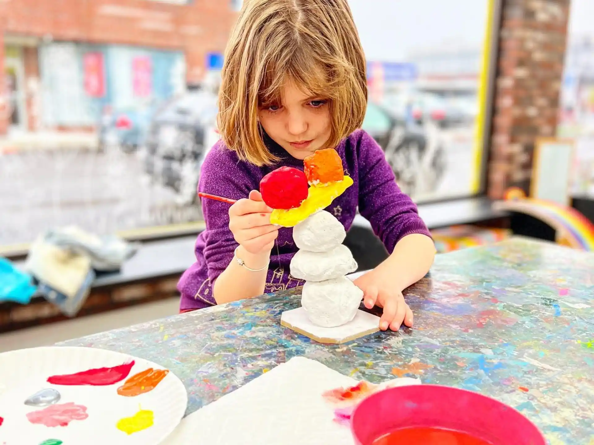 a girl playing with a toy