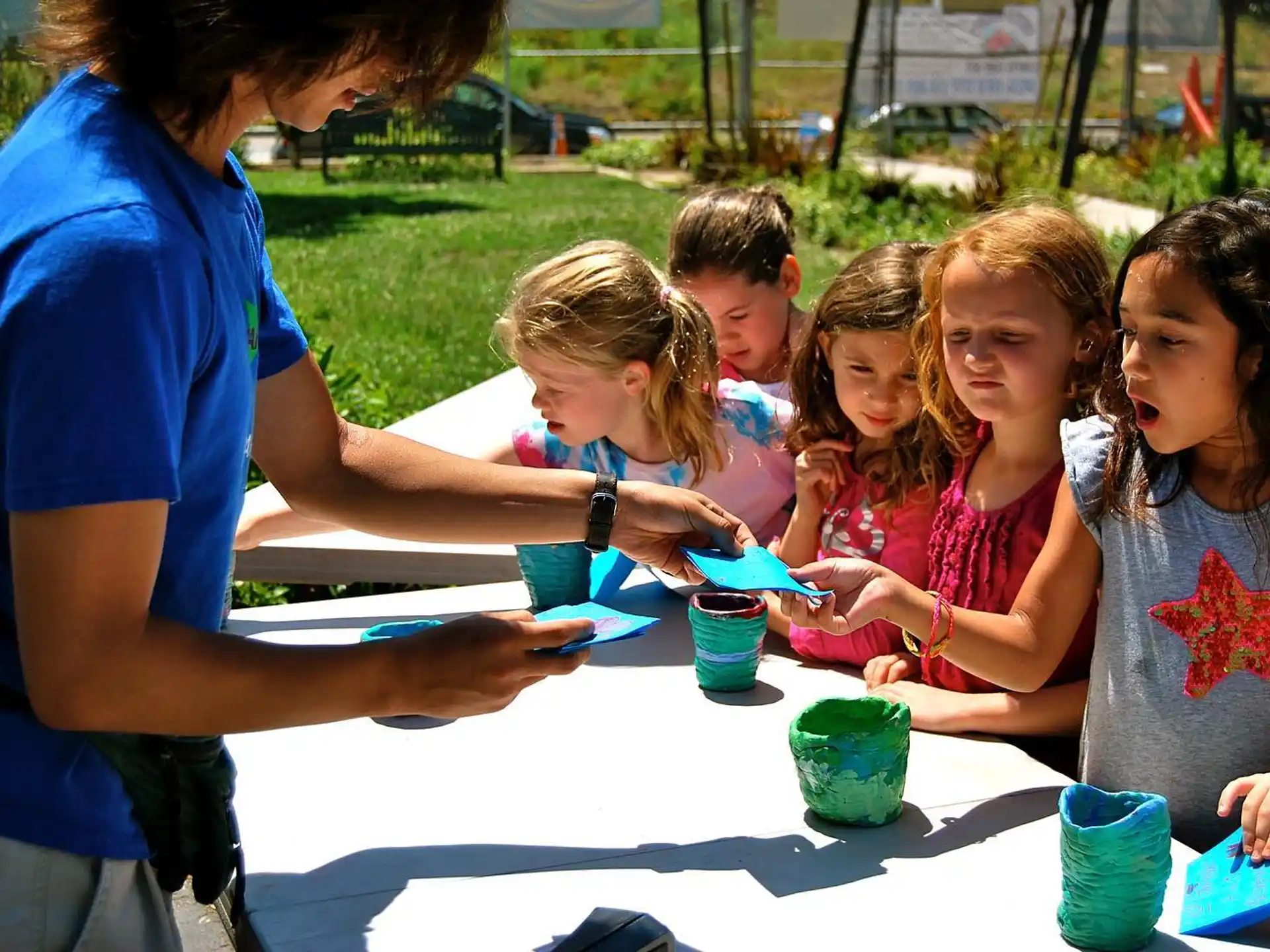 a person and several children sitting at a table