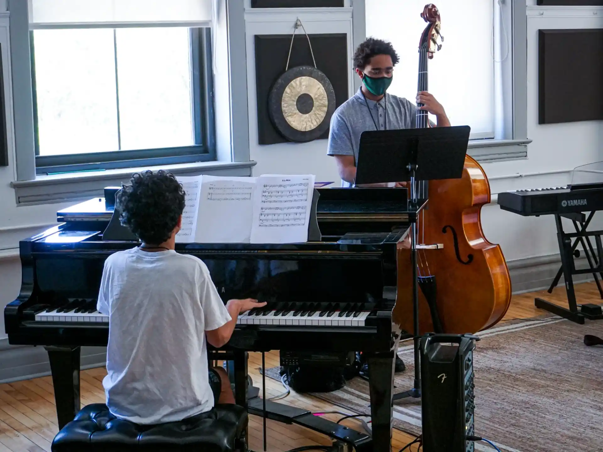 a man playing a piano with a boy playing the piano