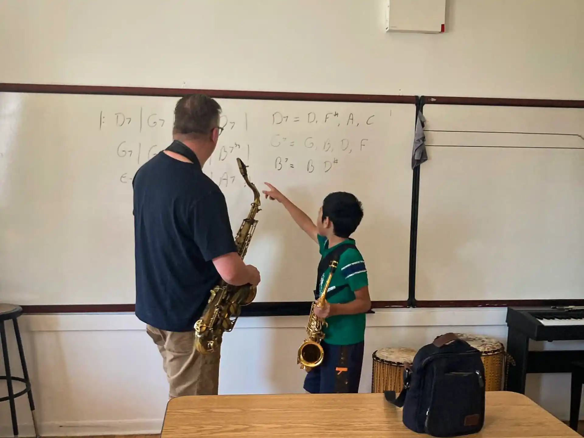 a person and a boy playing instruments