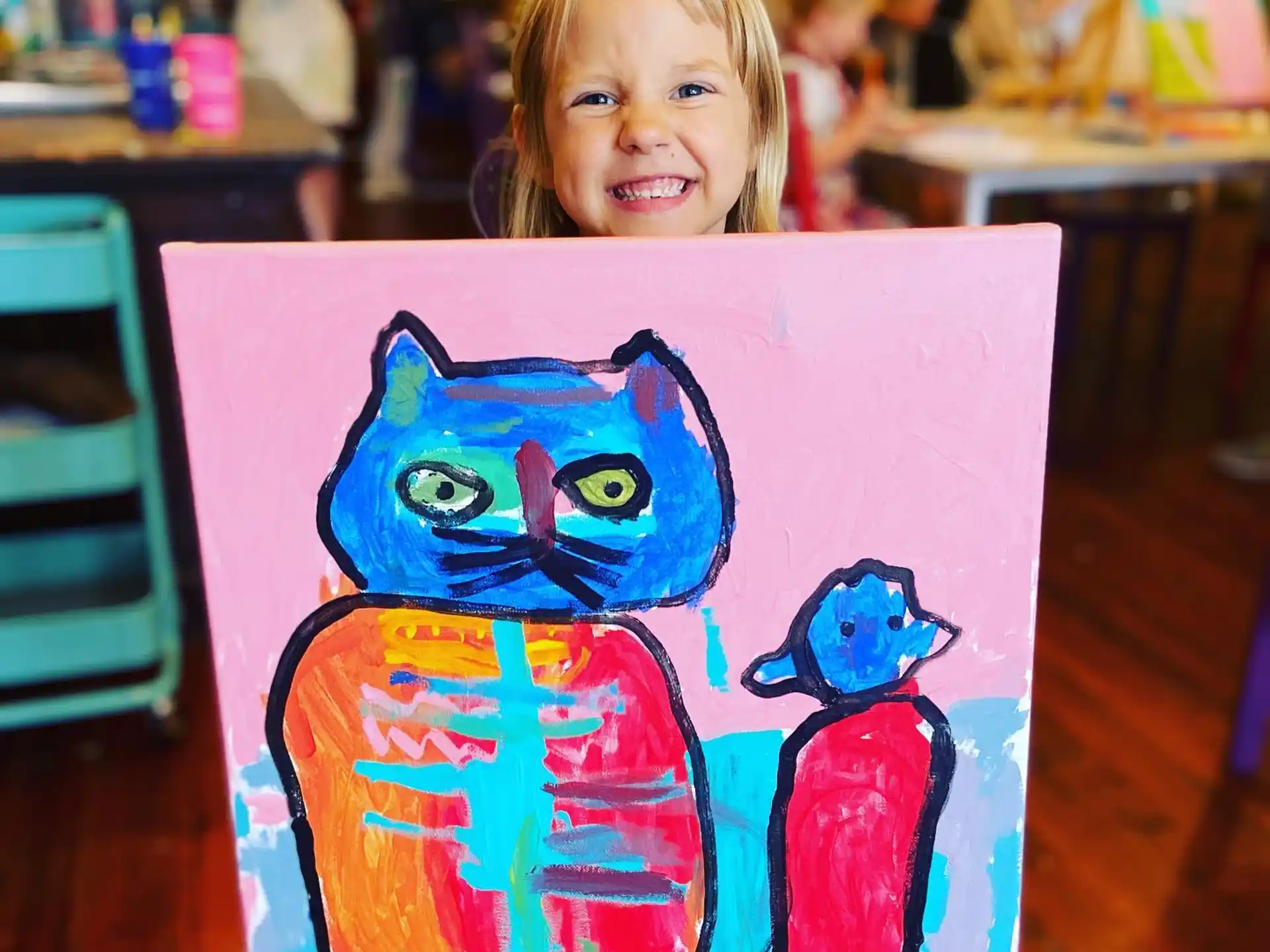 a child holding a painting