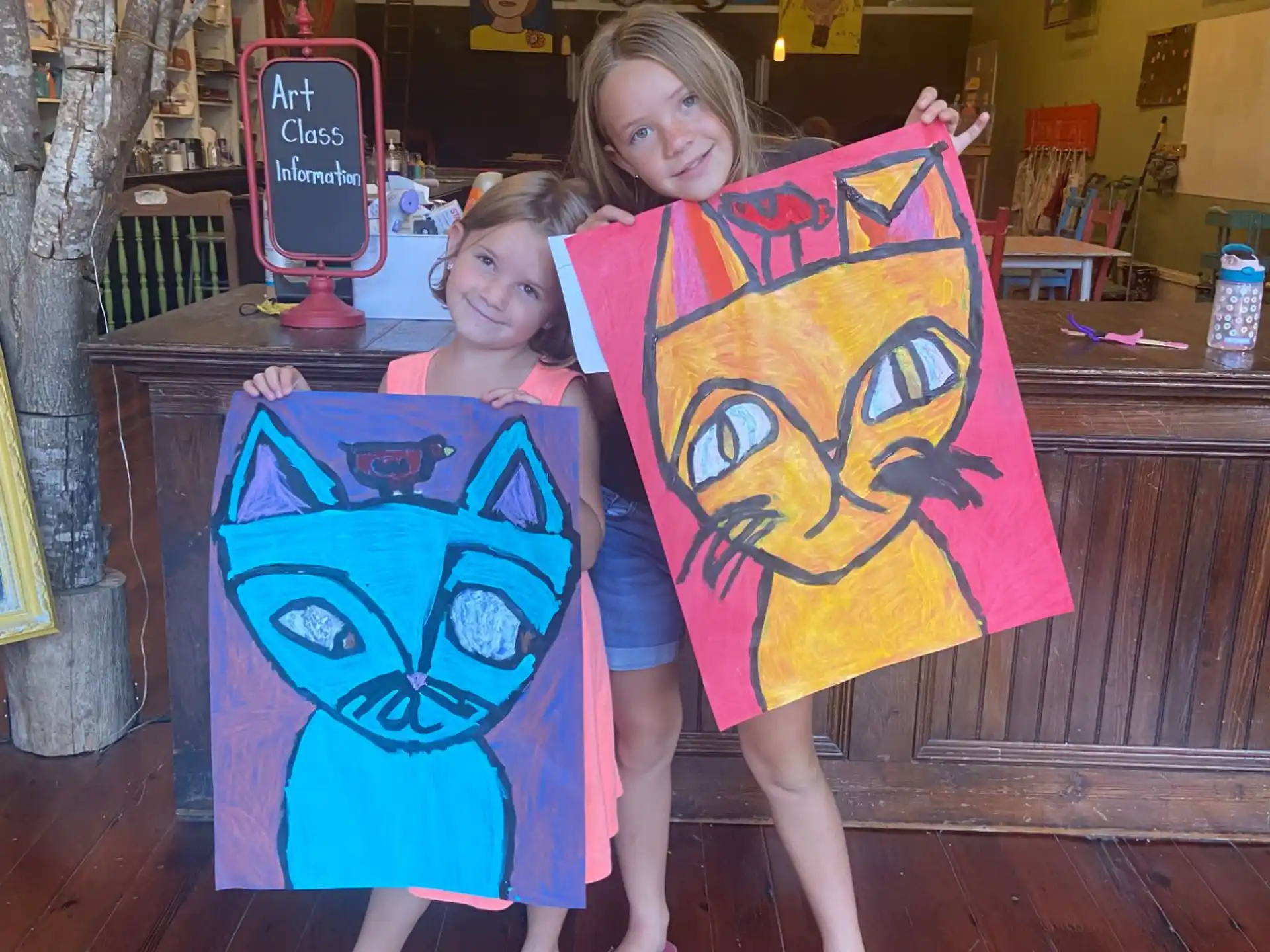 two girls holding kites