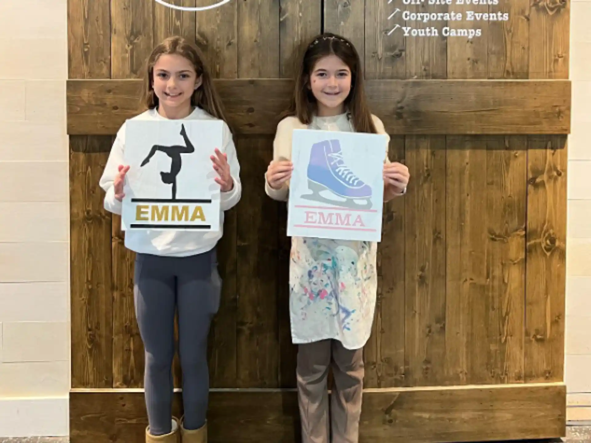 two girls holding signs