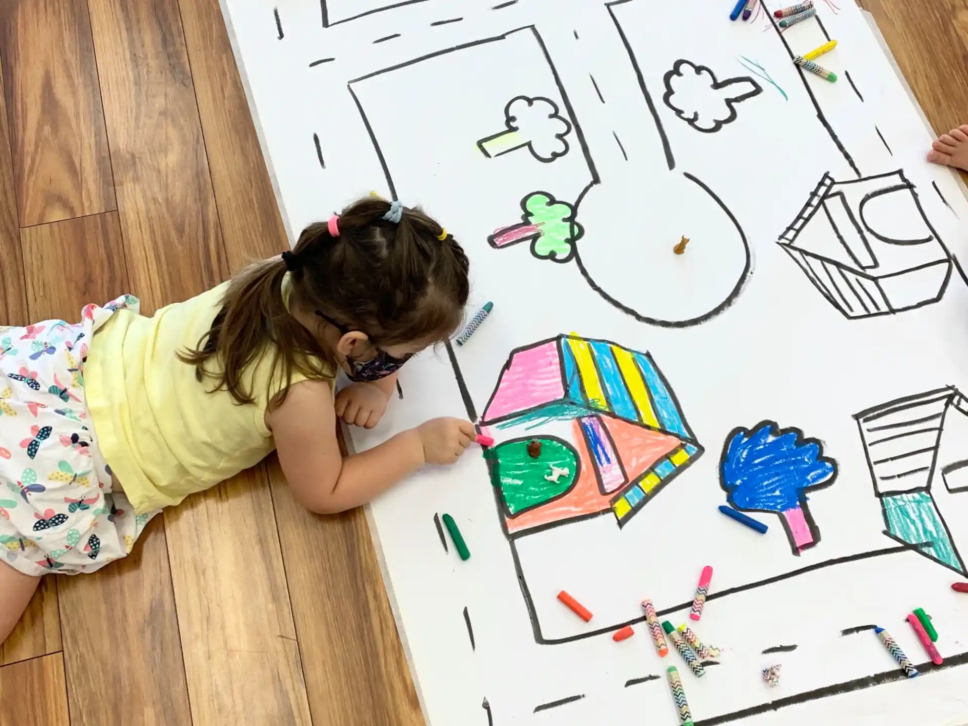 a girl drawing on a white board