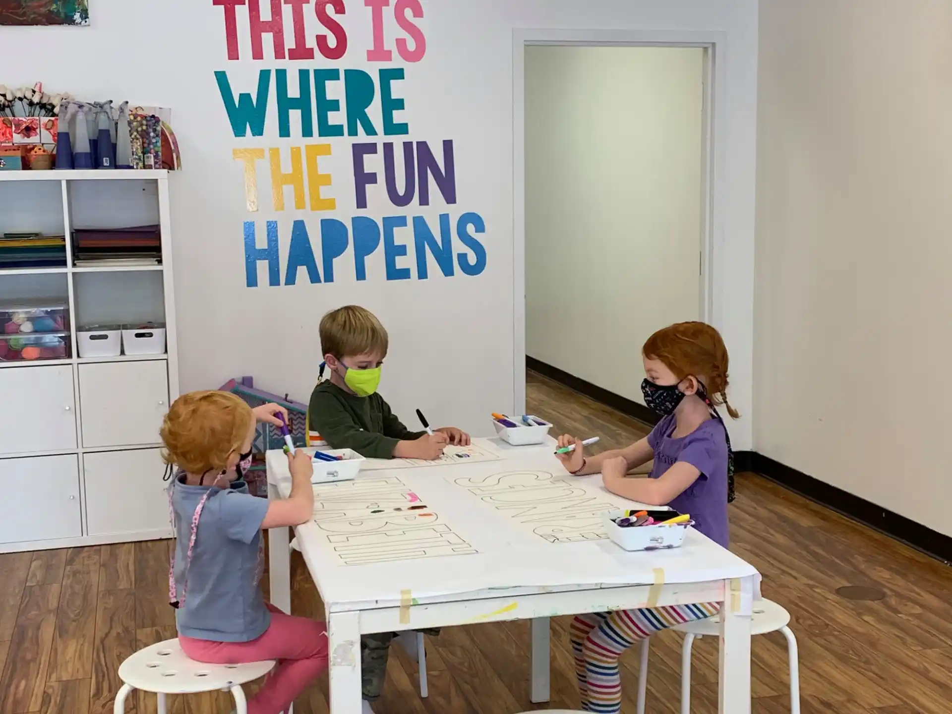 a person and two children sitting at a table