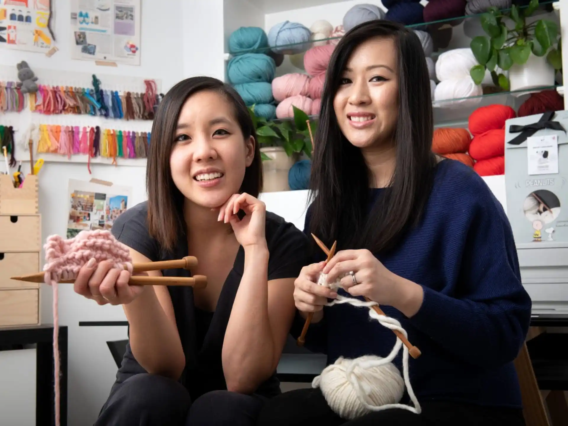 a couple of women holding a snake