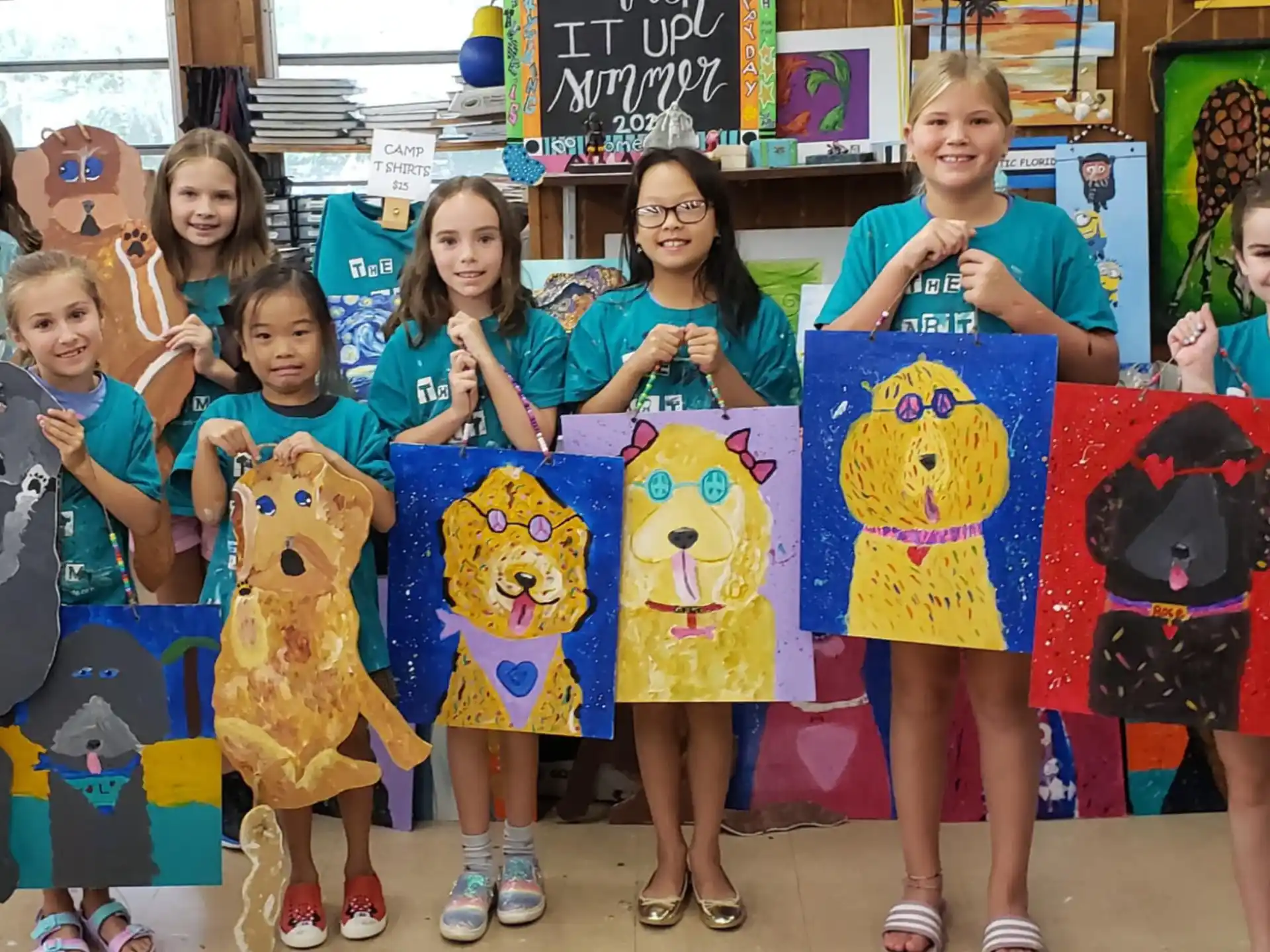 a group of girls holding up cartoon animals