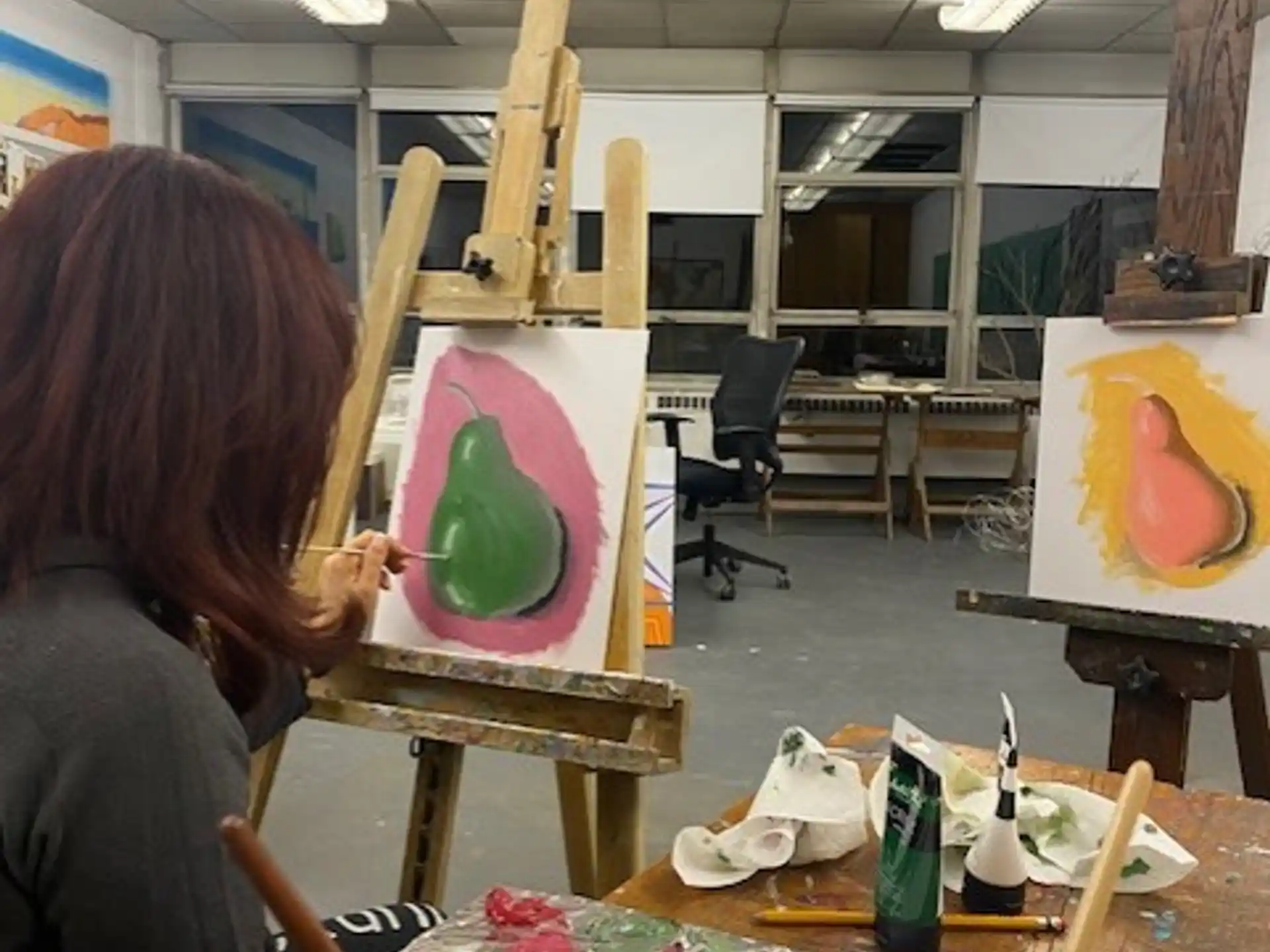 a woman painting on a table
