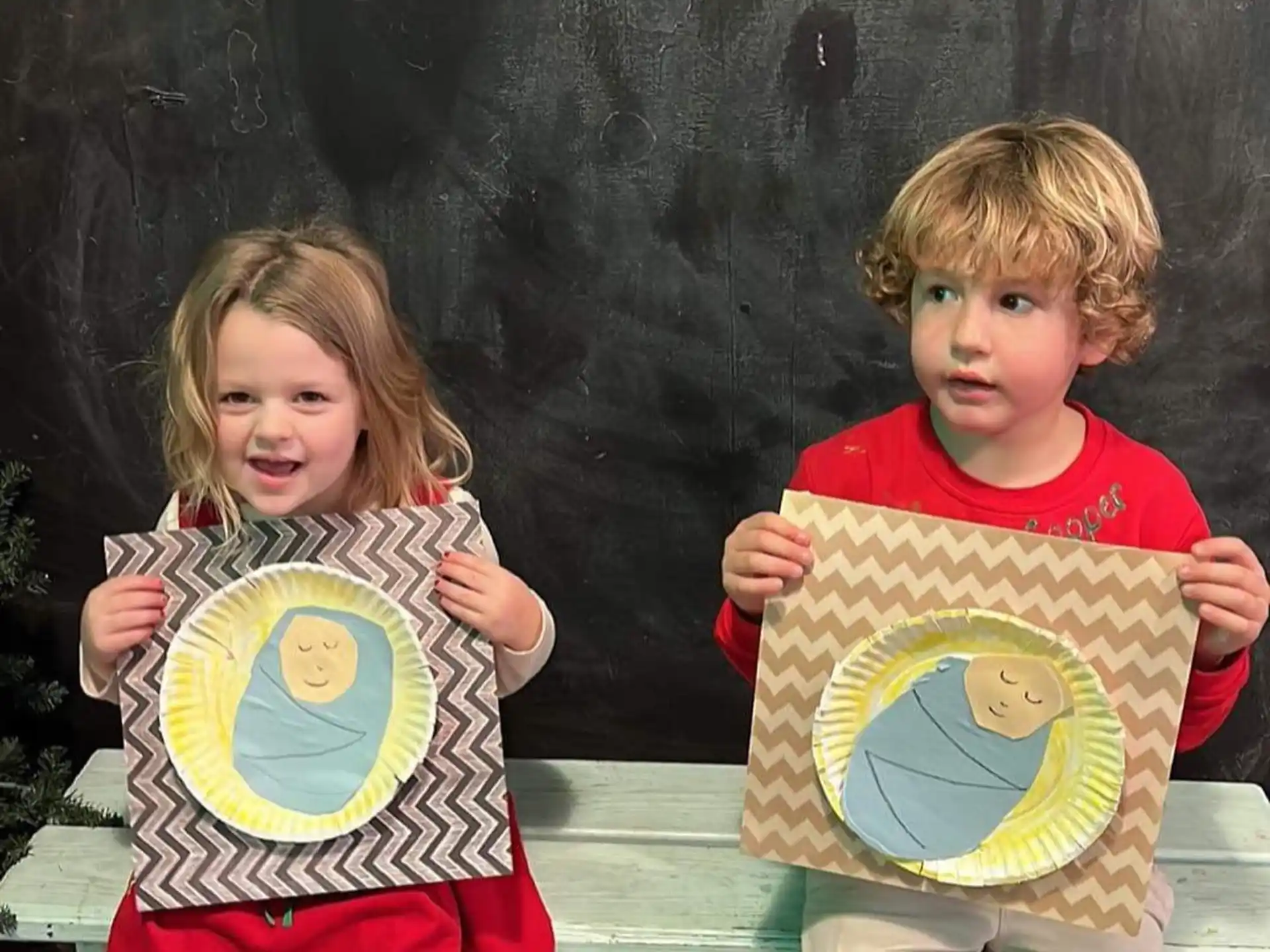 a couple of children holding signs