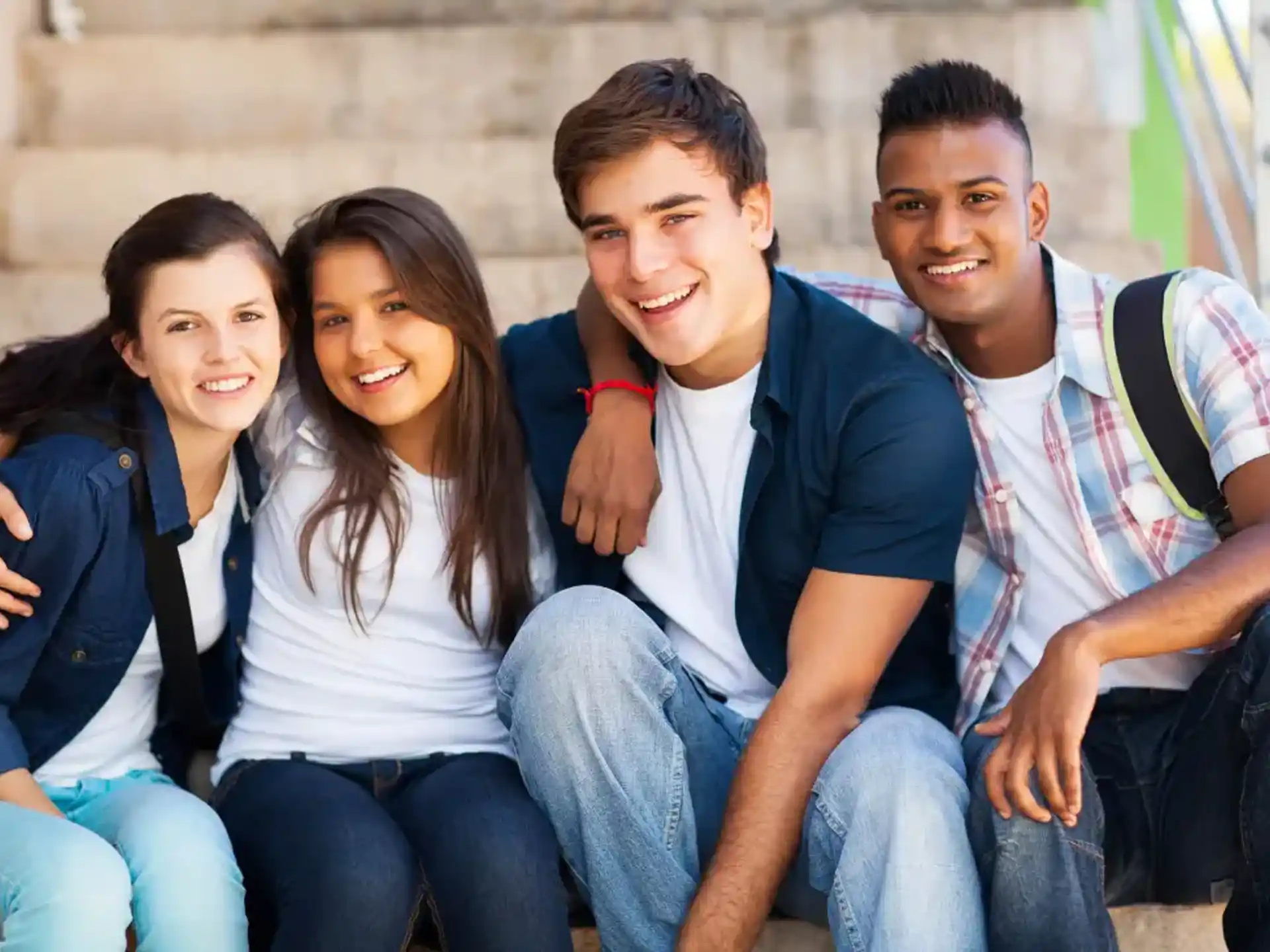 a group of people sitting together smiling