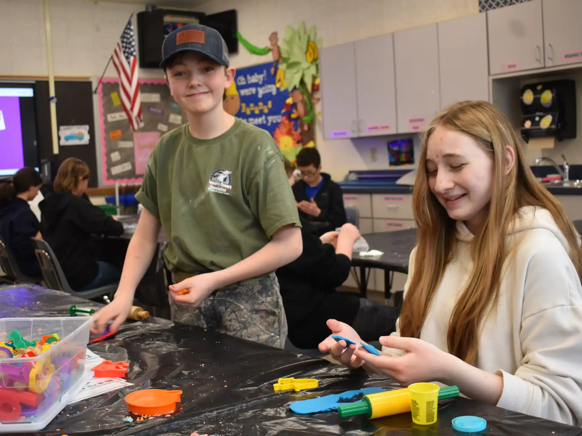 a boy and girl playing with toys