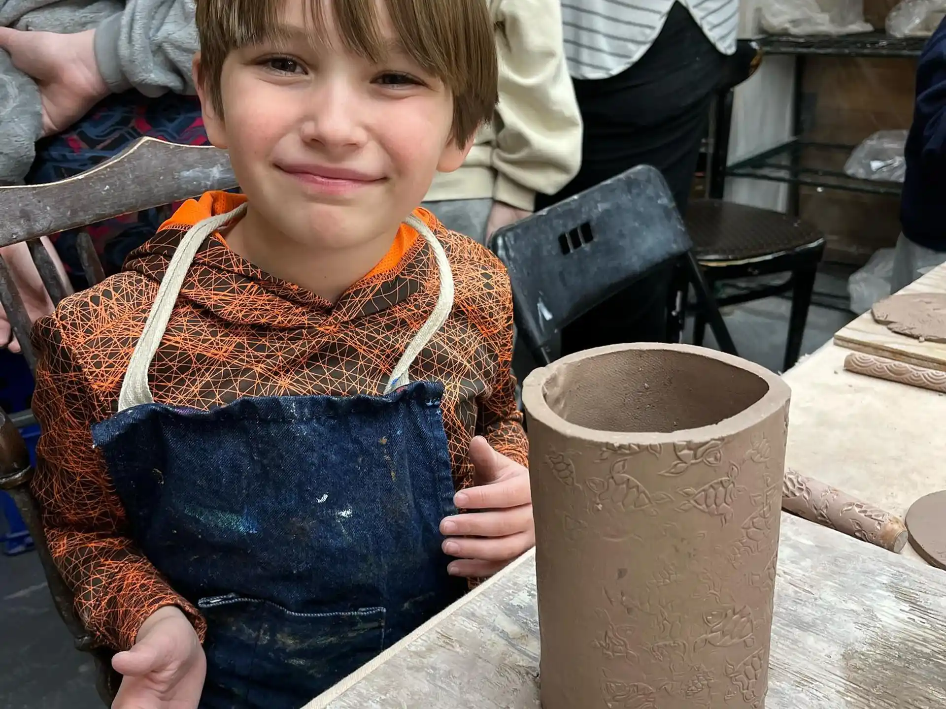 a boy holding a bucket