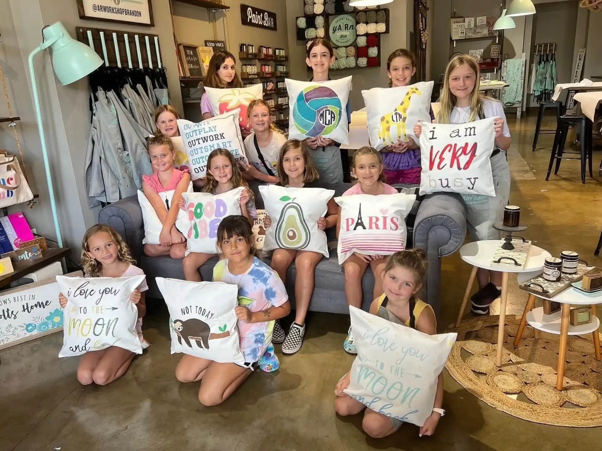 a group of people sitting on a couch holding signs