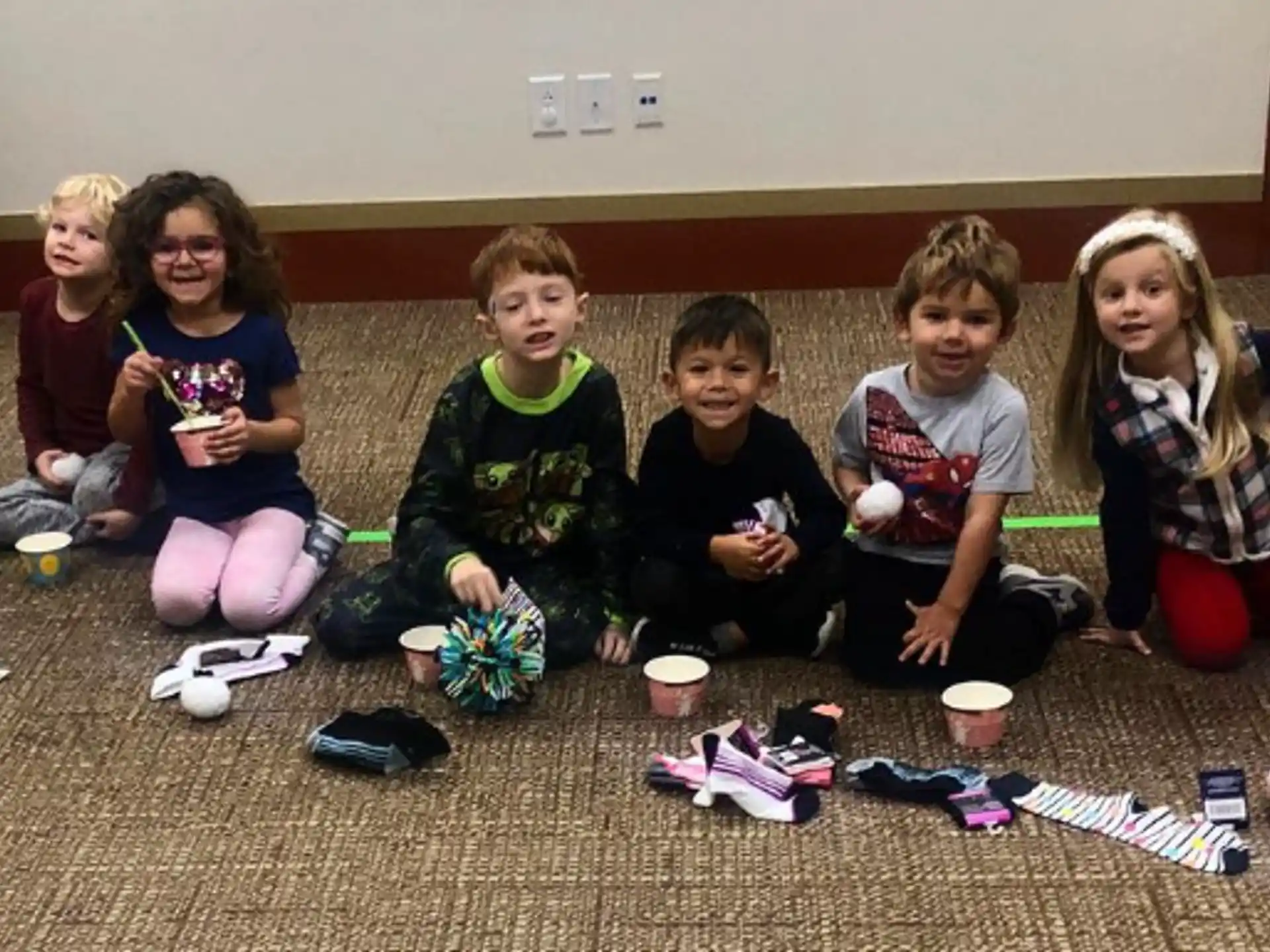 a group of children sitting on the floor