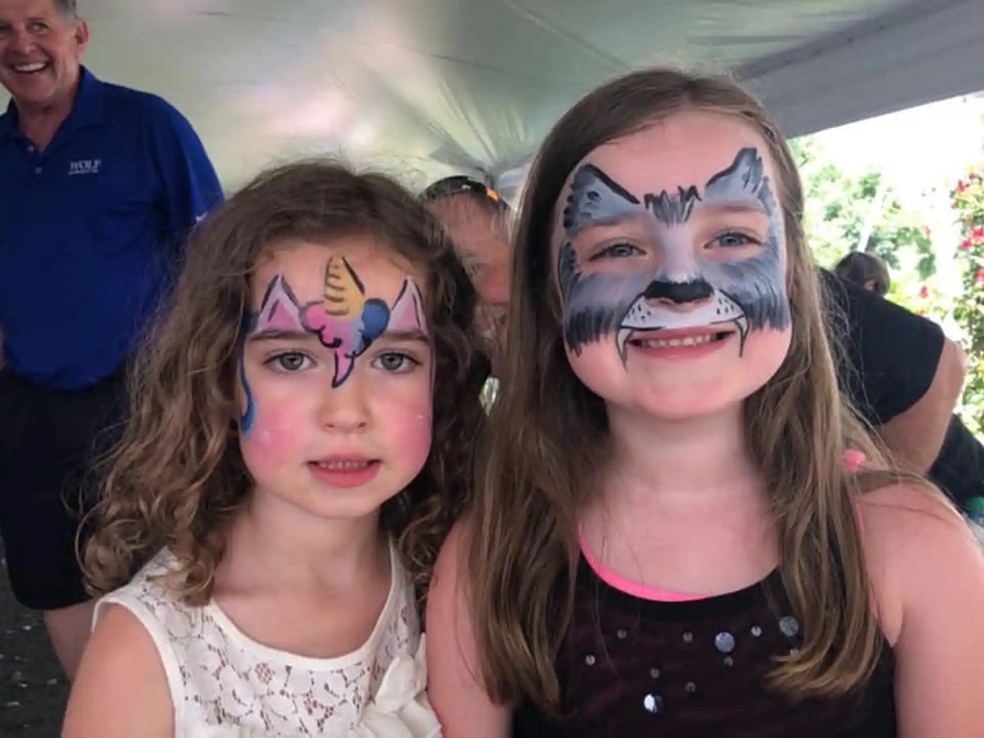 a man and a girl with face paint