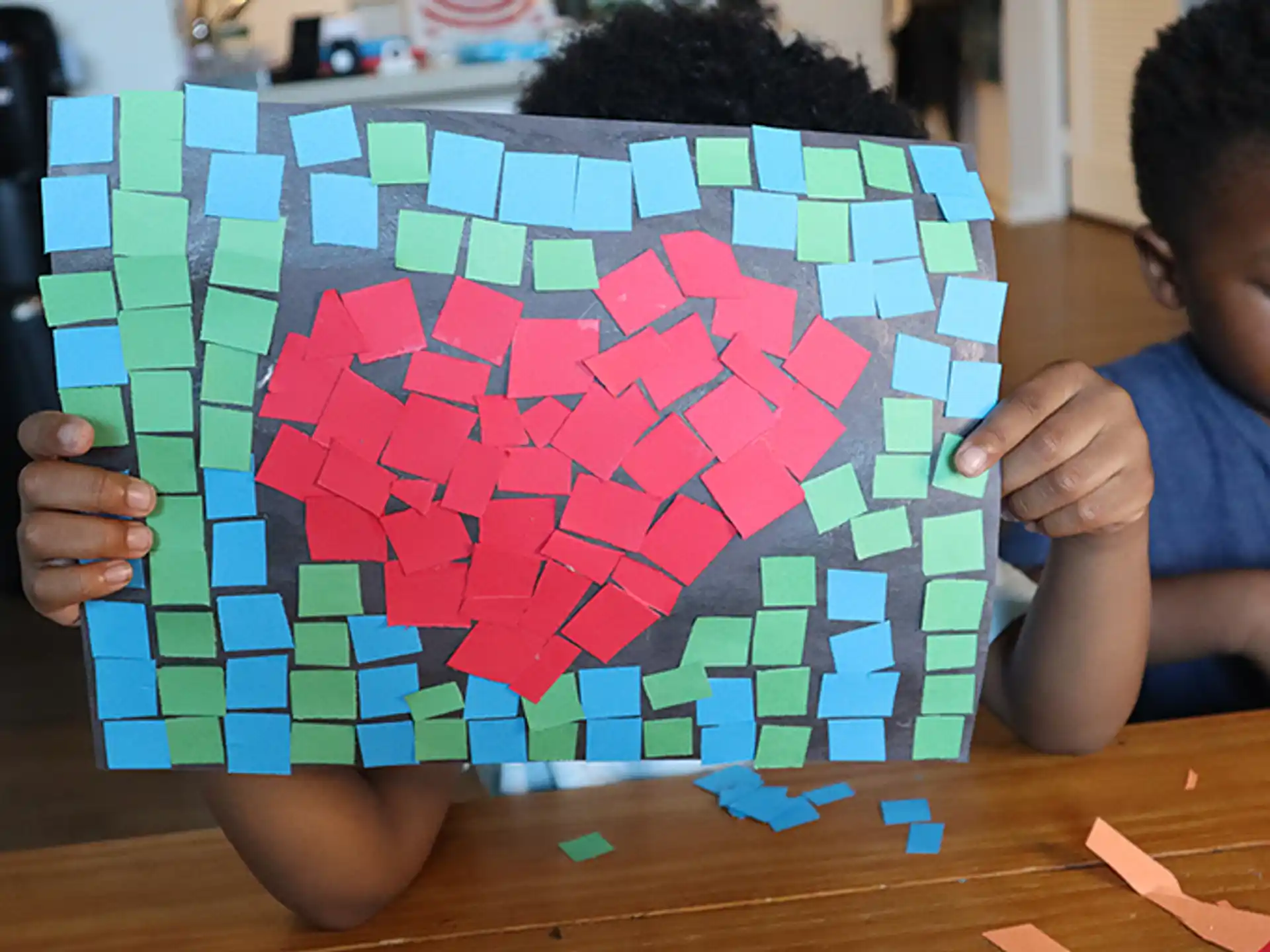 a child drawing on a piece of paper