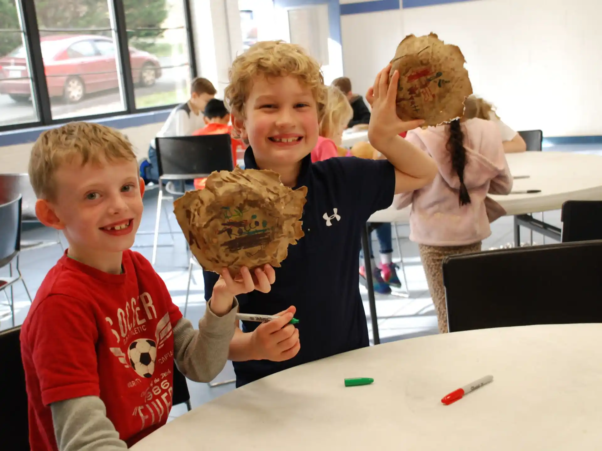 a couple of kids holding a cookie