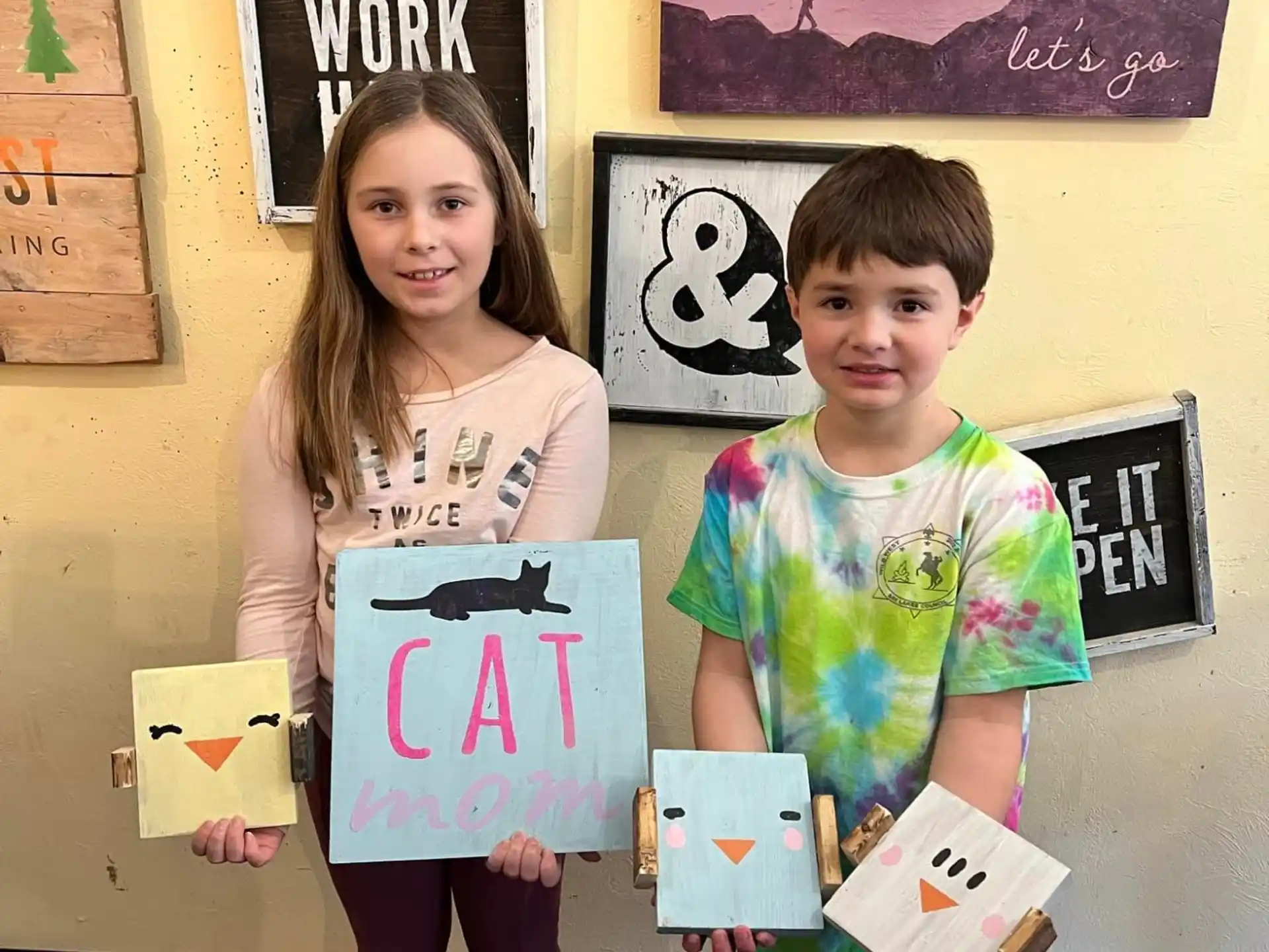 a couple of children holding signs