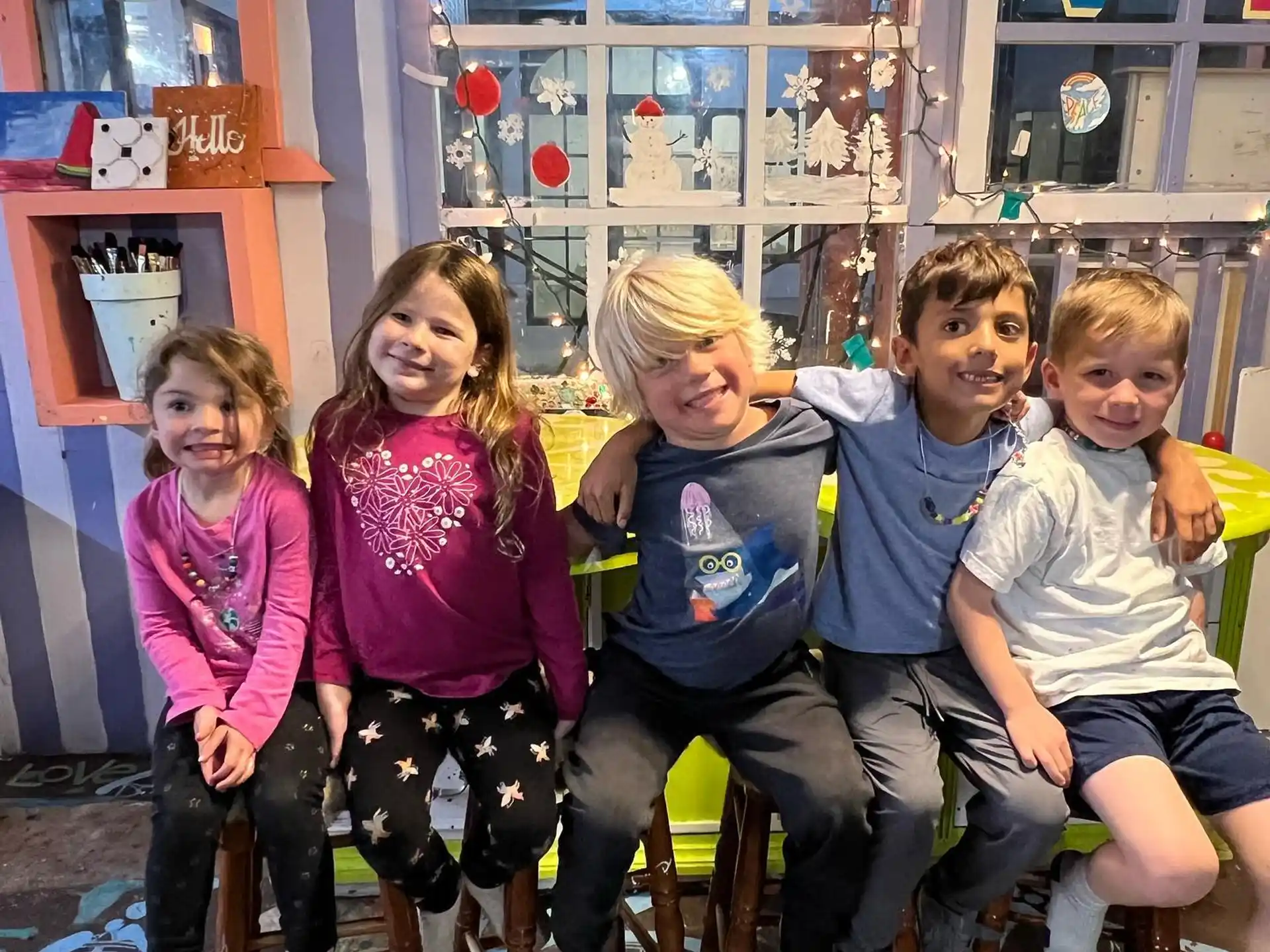 a group of children sitting on a bench