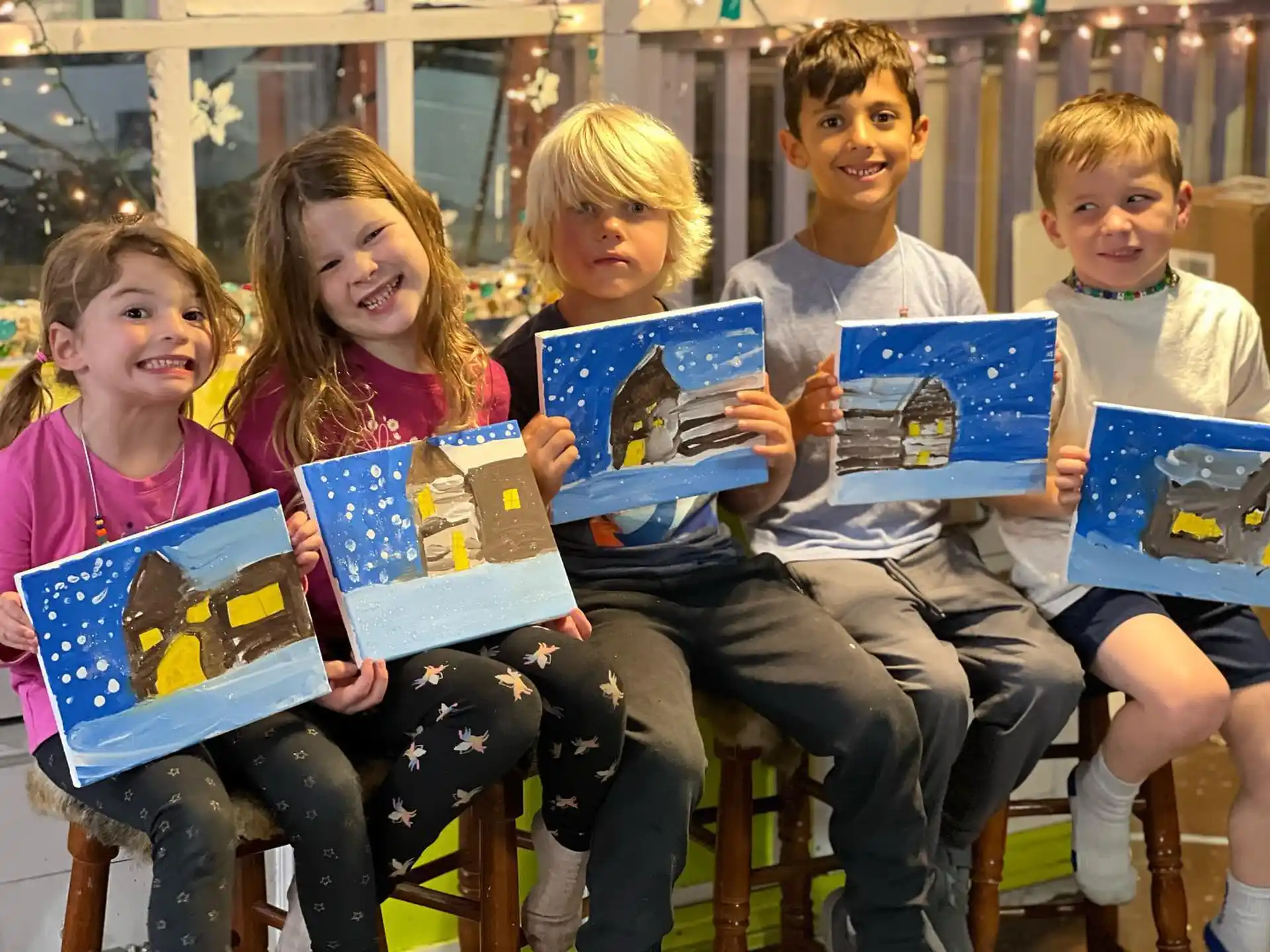 a group of children sitting on a bench holding books